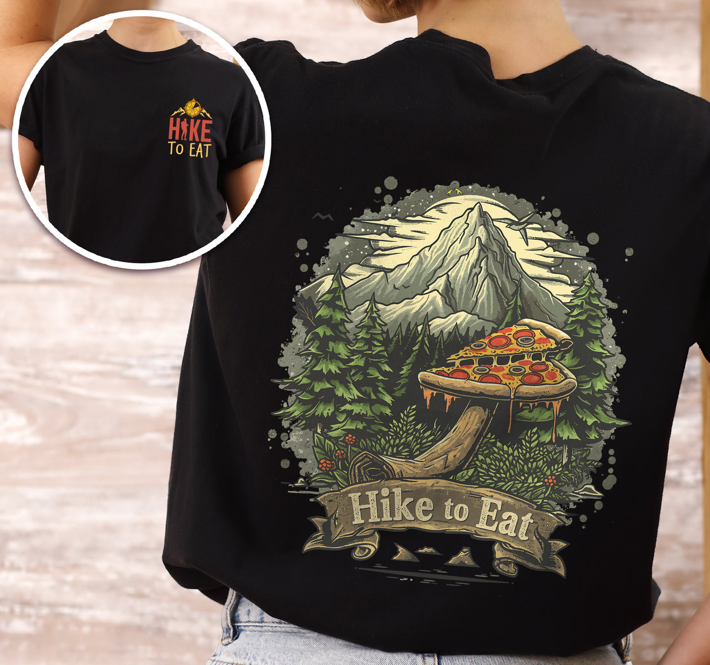 Black Hike to Eat t-shirt front and back view showing small chest logo and large back design featuring pizza mushroom in mountain forest scene with banner text