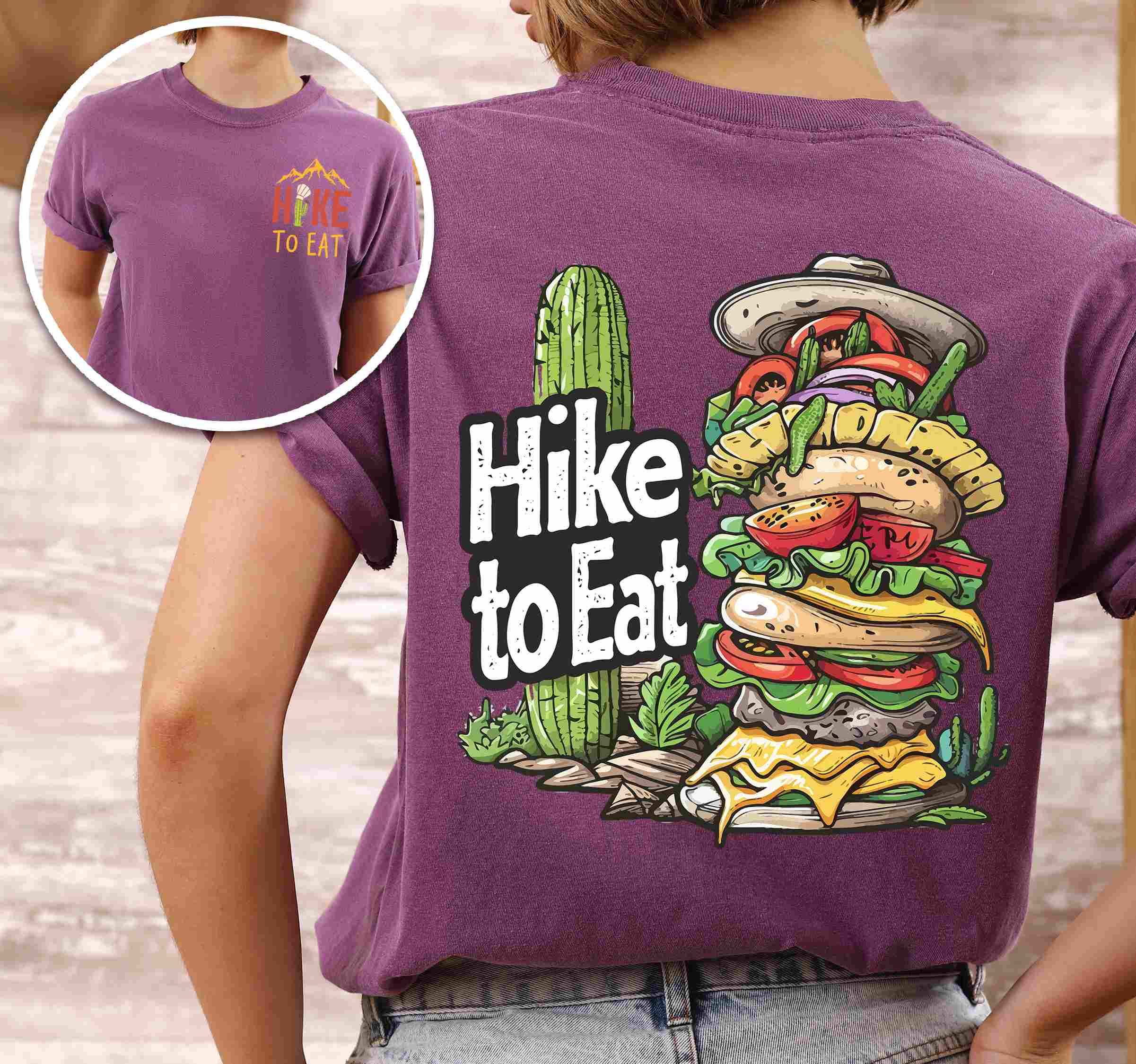 Woman wearing berrry "Hike to Eat" text in bold lettering front and back design, mountains, birds, illustrated stack of cheeseburger, and backpacker for burger lovers.