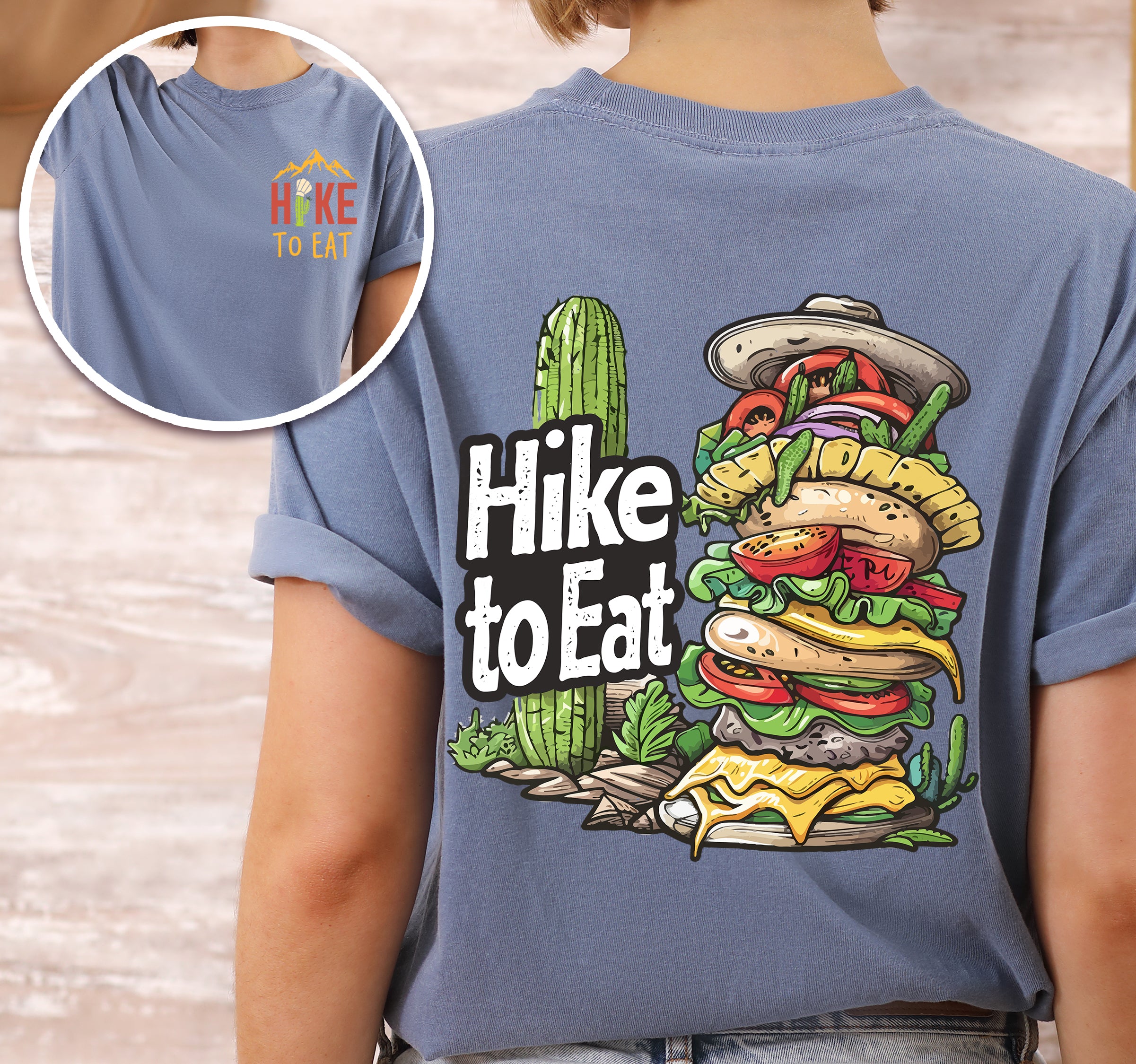 Blue Jean (Denim Blue) Hike to Eat t-shirt front and back view showing small colorful chest logo and large back design featuring towering burger with multiple layers, vegetables, and desert cactus landscape elements