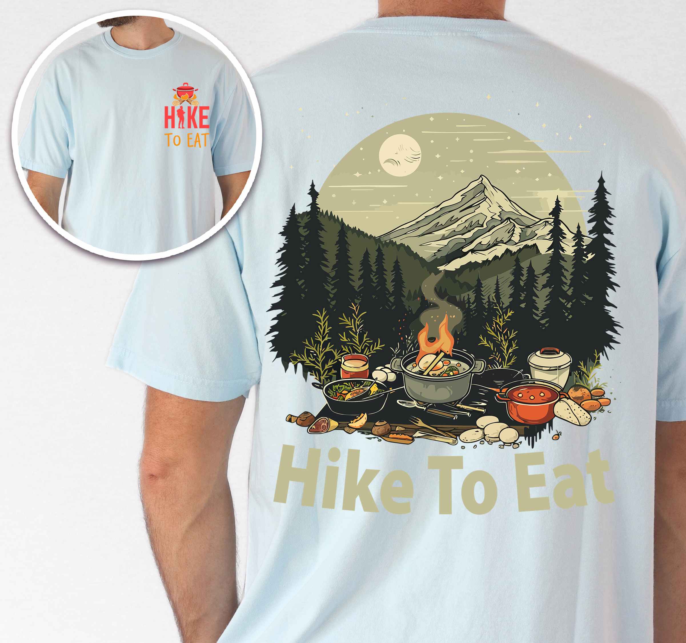 Man wearing chambray "Hike to Eat" text in bold lettering front and back design, mountains, birds, illustrated camping feast, and backpacker for campfire cooking enthusiasts.