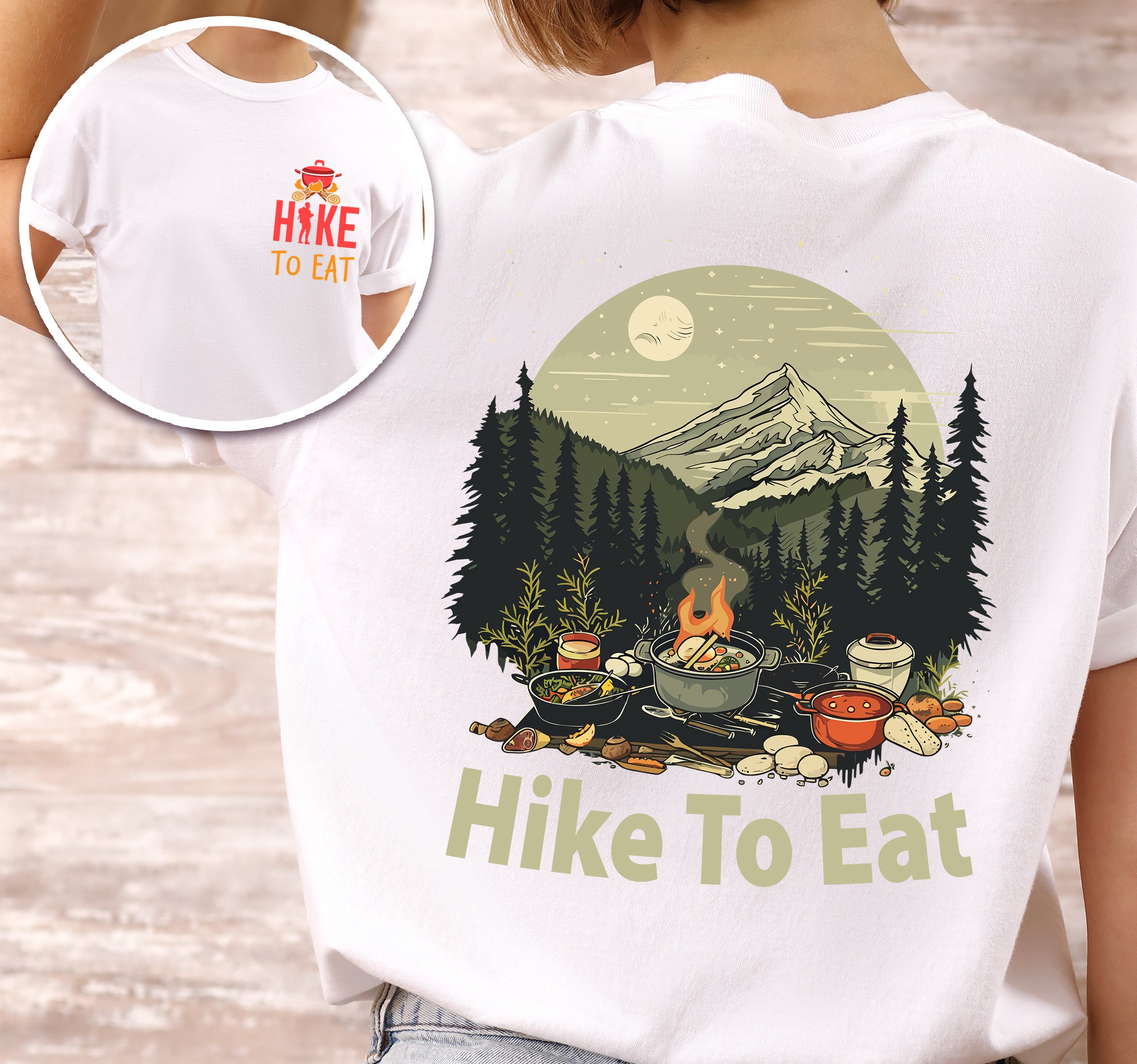 White Hike to Eat t-shirt front and back view showing small red chest logo and large back design featuring nighttime camping scene with campfire, cooking pots, food, mountains, pine trees, and starry sky with moon