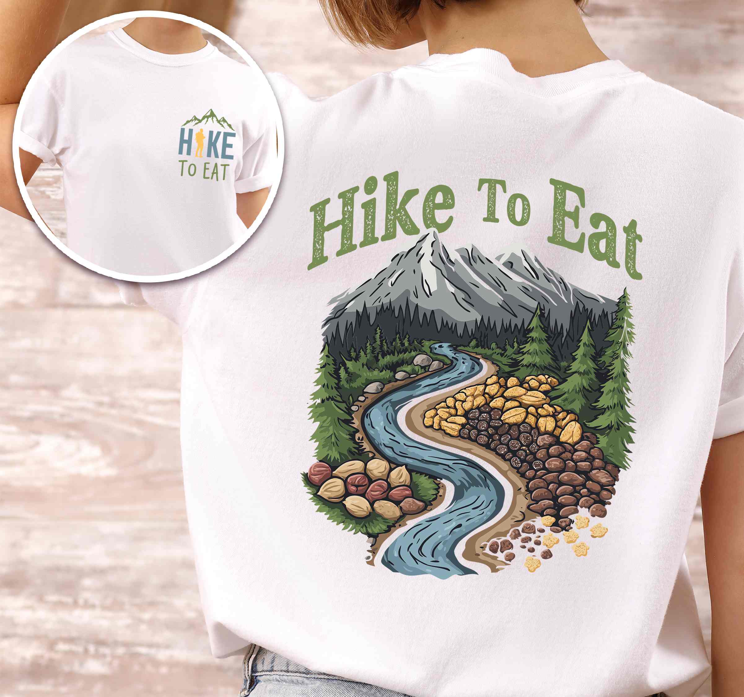 Woman wearing white "Hike to Eat" text in bold lettering front and back design, mountains, birds, illustrated nuts and fruit trail mix, and backpacker for trail mix lover.