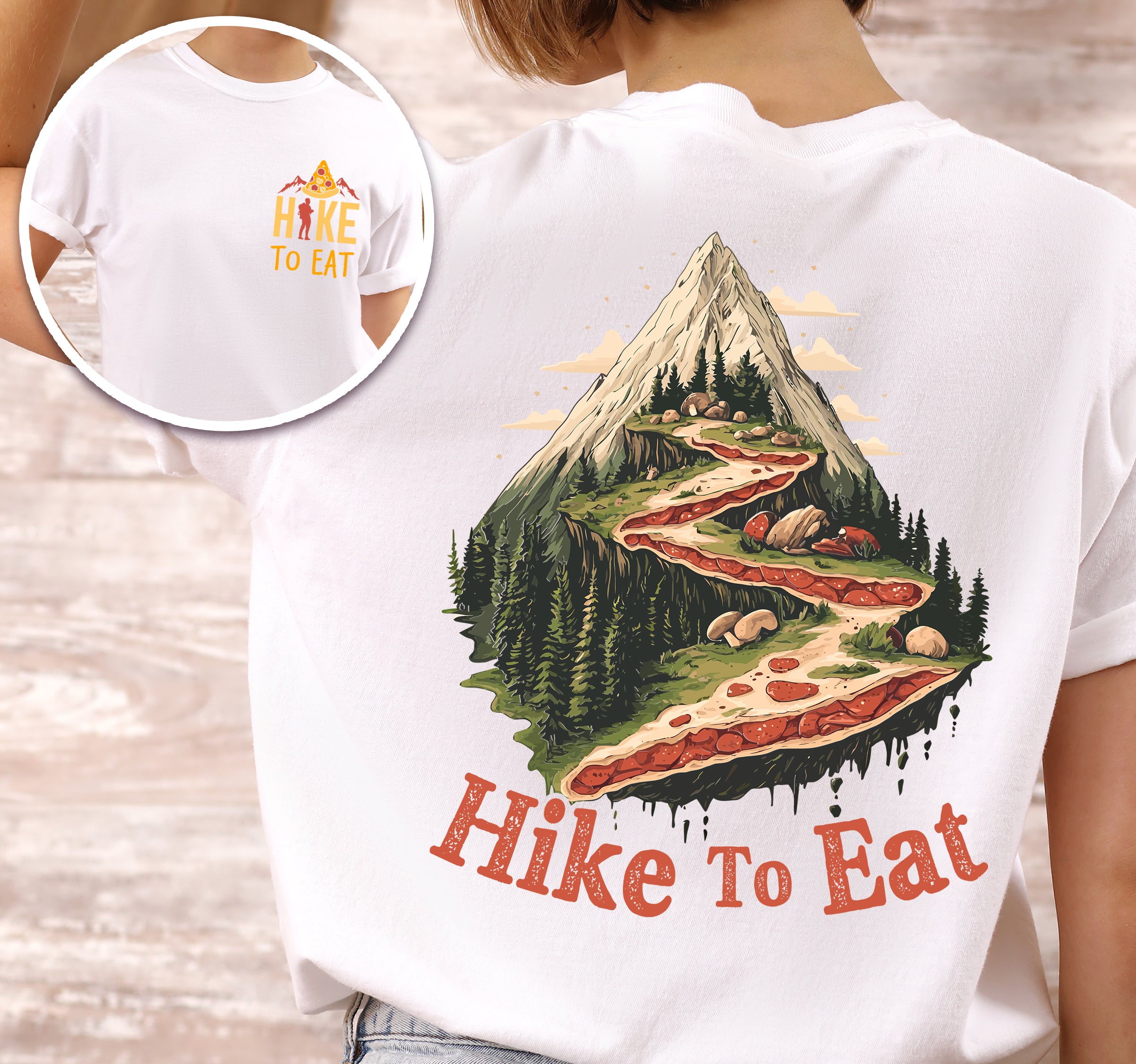 woman wearing white "Hike to Eat" text in bold lettering front and back design, mountains, birds, illustrated stack of pizza slices, and backpacker for pizza lovers.