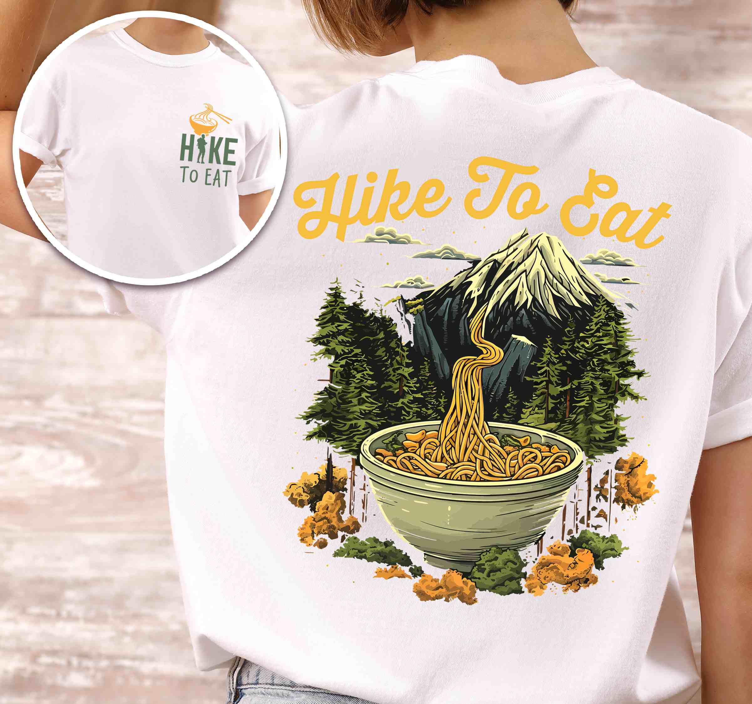 Woman wearing white "Hike to Eat" text in cream lettering, mountains, birds, illustrated bowl of ramen noodles, and backpacker for ramen lovers.