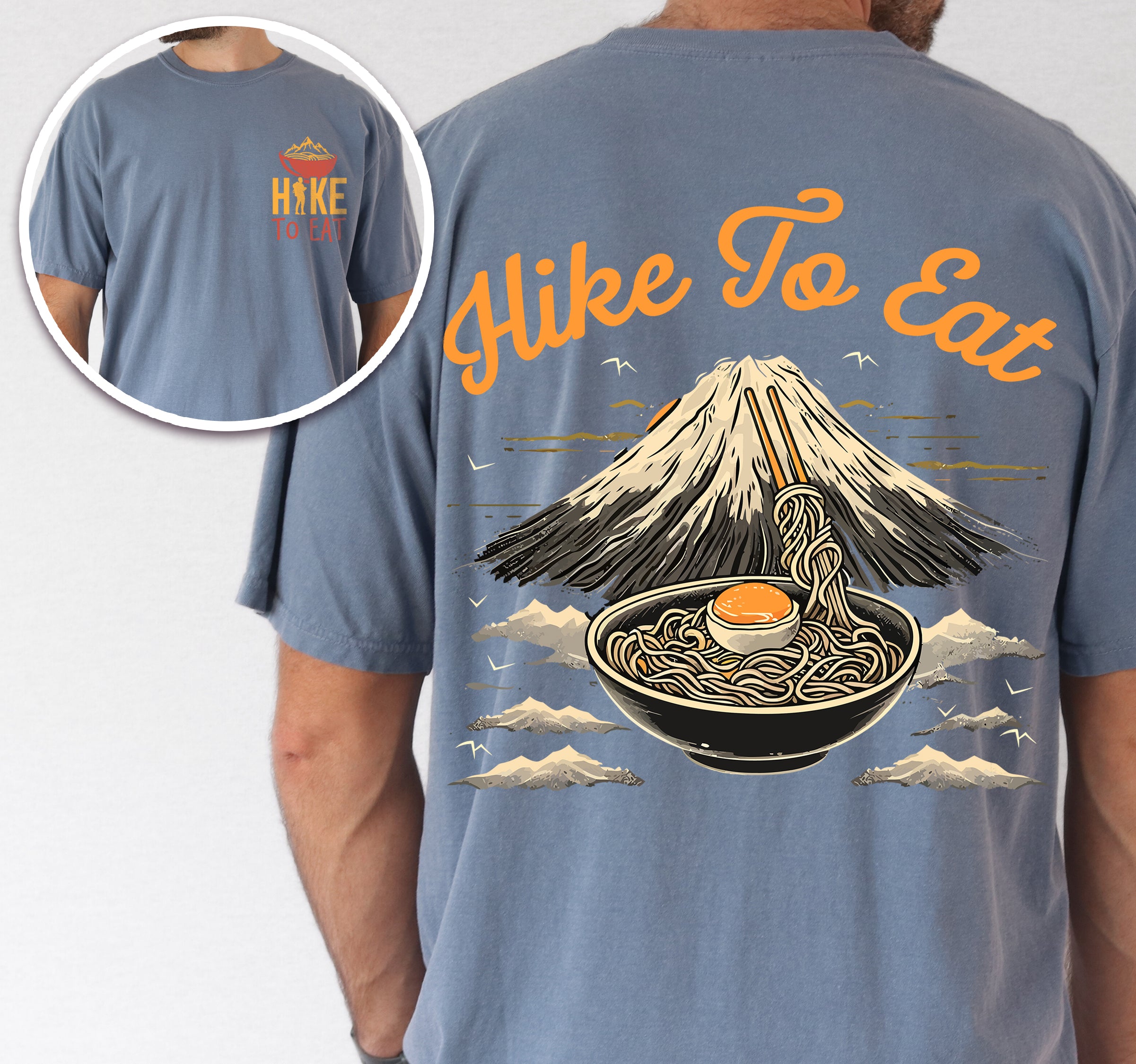 Blue Jean (Denim Blue) Hike to Eat t-shirt front and back view showing small orange chest logo with ramen bowl and large back design featuring black steaming ramen bowl with swirling noodles and soft-boiled egg in front of sketched Mount Fuji landscape with clouds.