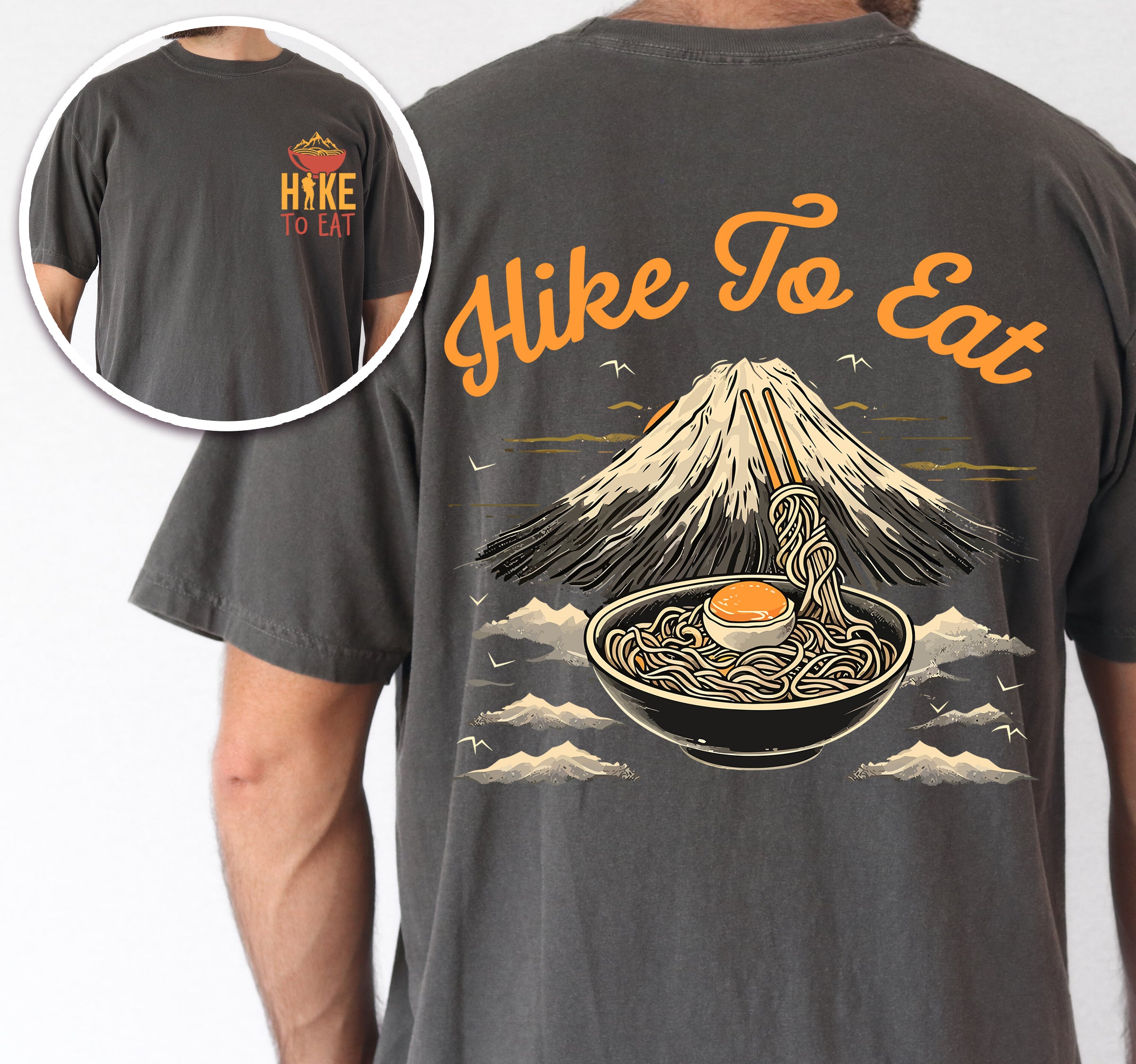 Pepper (Dark Gray) Hike to Eat t-shirt front and back view showing small orange chest logo with ramen bowl and large back design featuring black steaming ramen bowl with swirling noodles and soft-boiled egg in front of sketched Mount Fuji landscape with clouds.