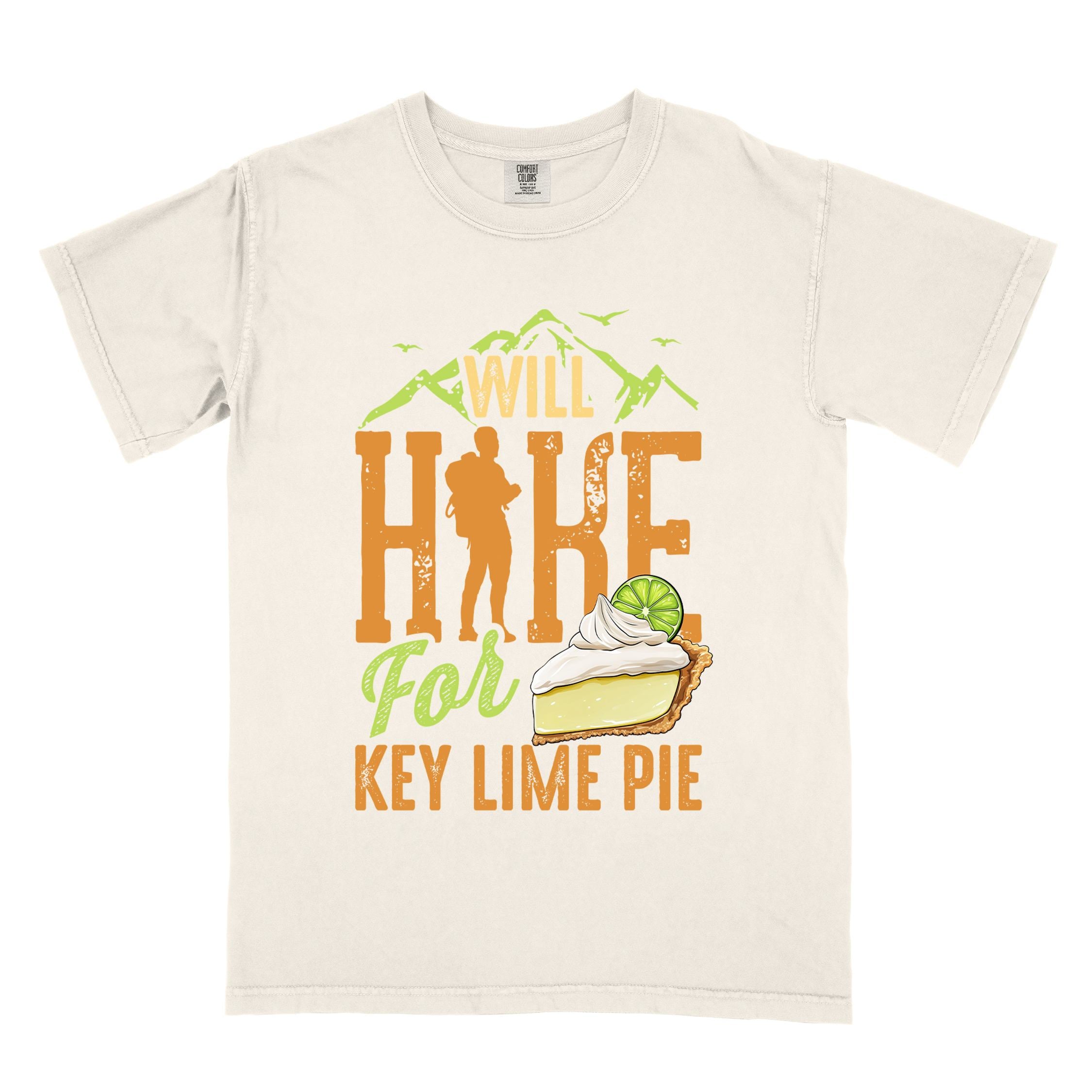 Ivory "Will Hike for Key Lime Pie" colored vintage tee with bold typography, illustrated slice of key lime pie, mountains, birds, and backpacker with the sweet tooth.