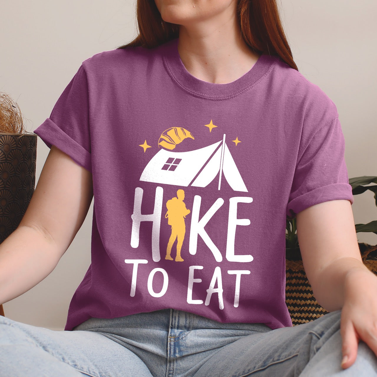 Woman wearing Berry Hike to Eat brand philosophy vintage tee with white camping tent croissant moon stars character silhouette with backpack integrated into typography on Comfort Colors shirt for food motivated adventurers, outdoor enthusiasts and hikers
