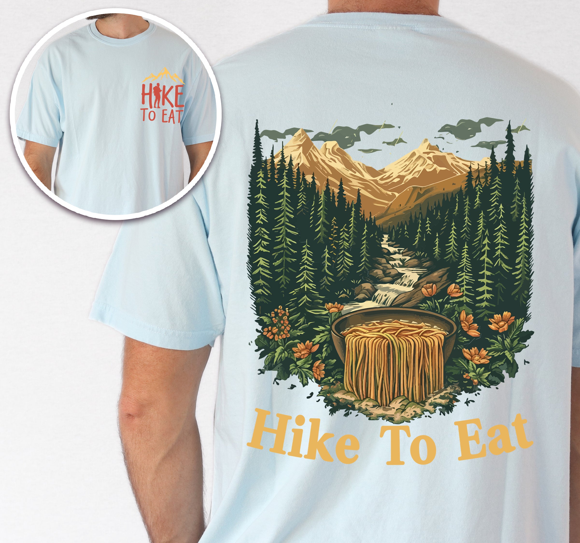 Chambray (Light Blue) Hike to Eat t-shirt front and back view showing small colorful chest detail and large back design featuring mountain landscape with crystal-clear stream cascading through evergreen forests and wildflowers, transforming into flowing ramen noodles in a rustic wooden bowl.
