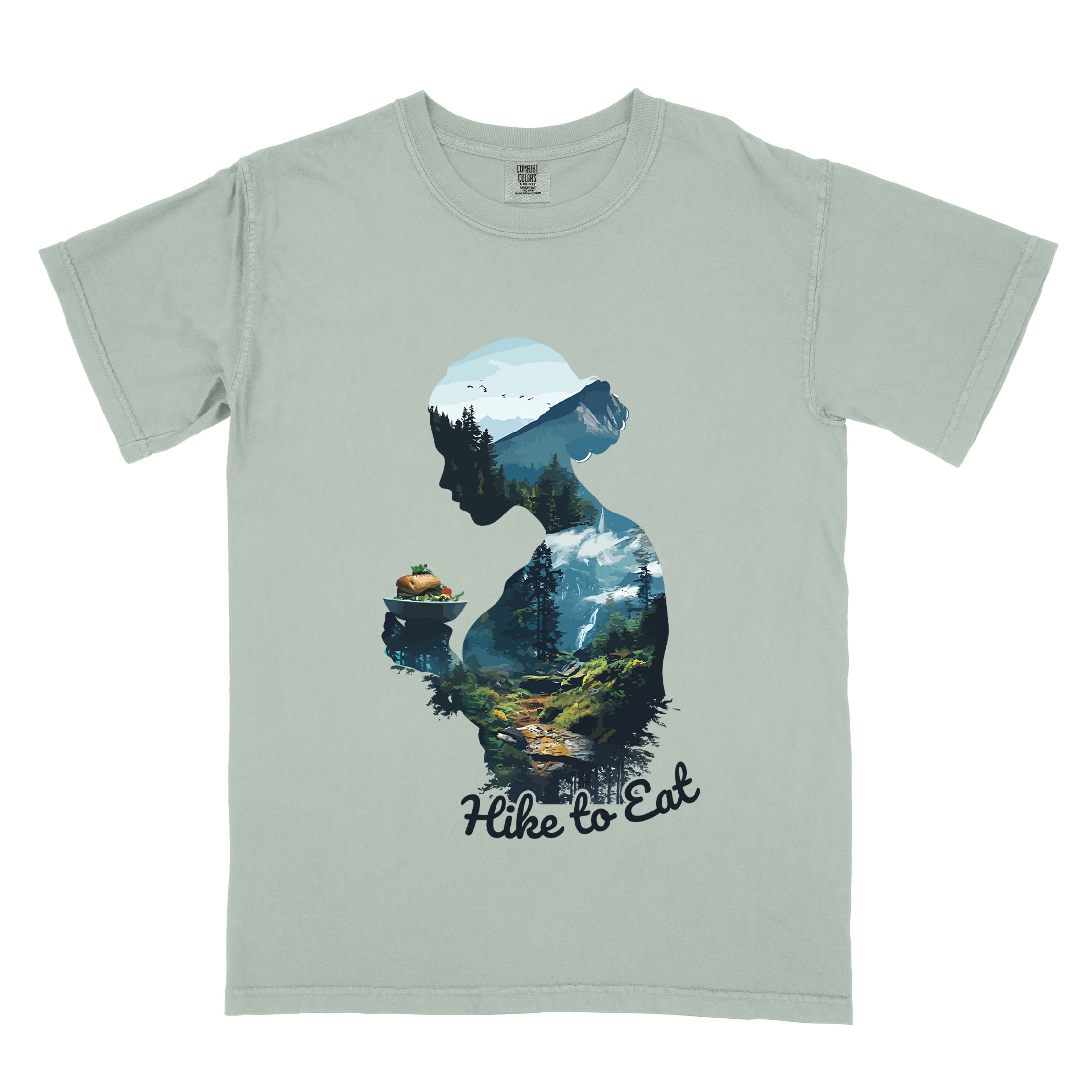 Wilderness Within Hike to Eat t-shirt featuring double exposure design of hiker silhouette holding ramen bowl merged with mountain forest landscape on sage green Comfort Colors shirt in bay (green) color