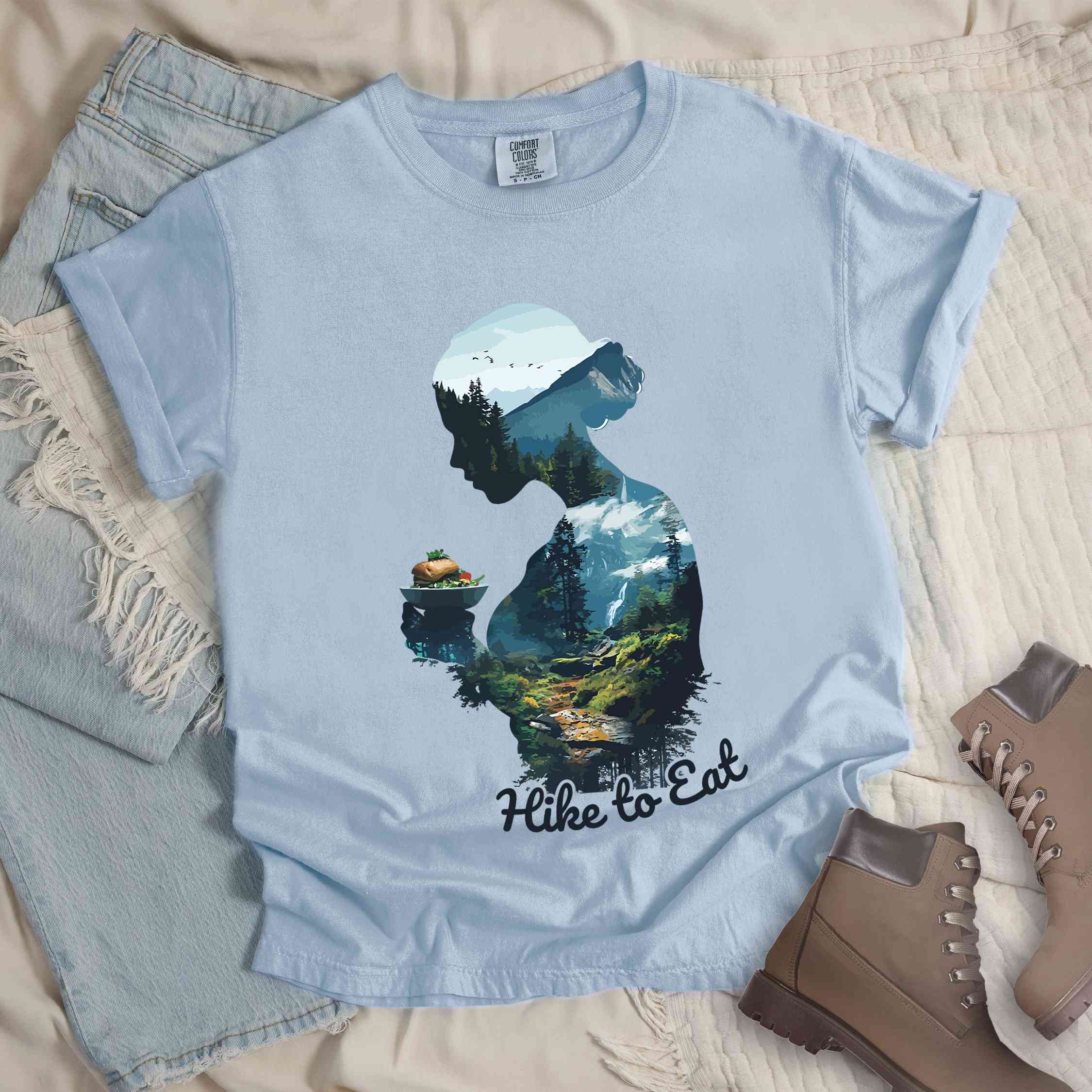 Chambray "Hike to Eat" colored vintage statement tee with text in cream lettering, mountains, birds, silhouette, illustrated sandwich, and backpacker for sandwich lovers.