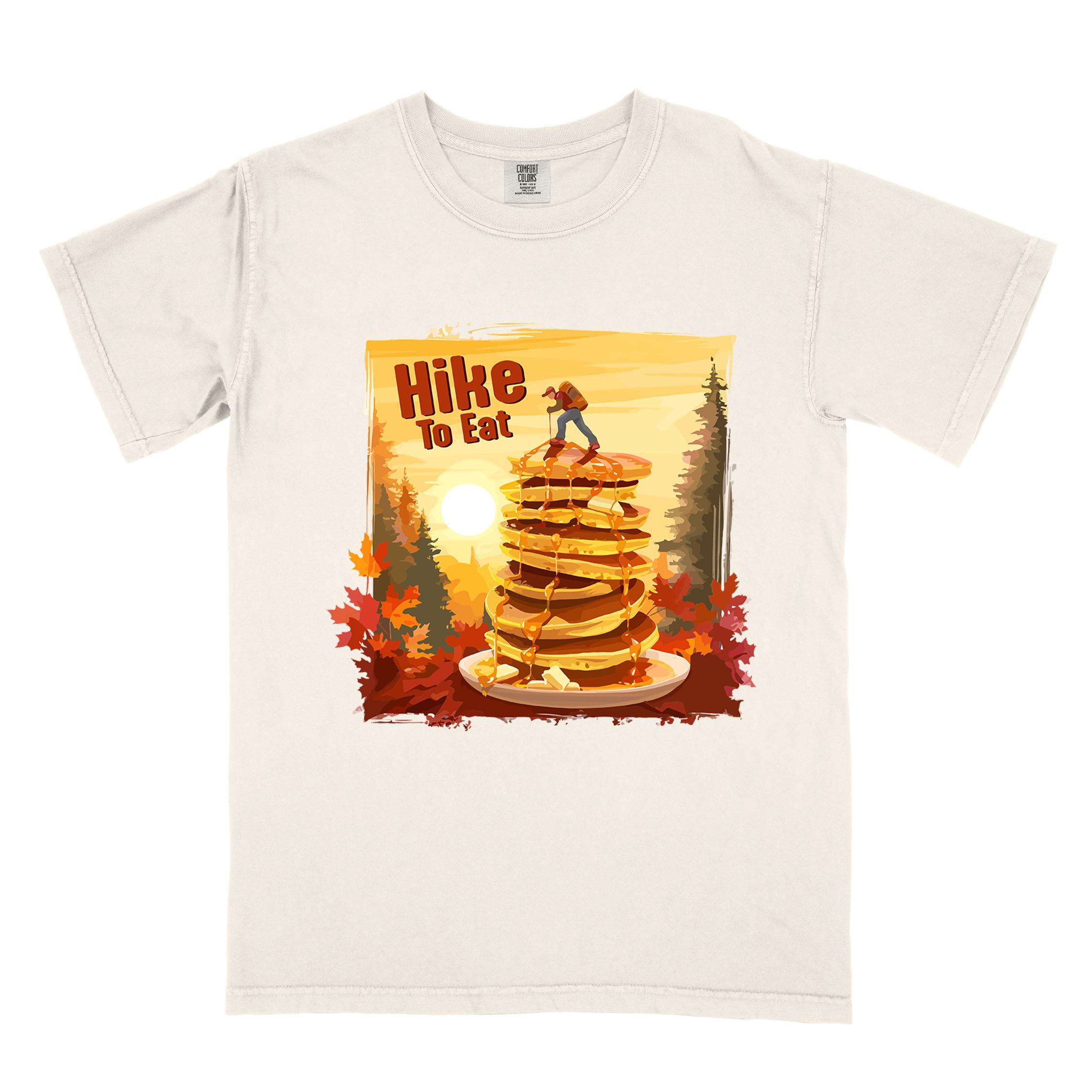 Ivory "Hike to Eat" colored vintage statement tee with text in bold lettering, mountains, birds, silhouette, illustrated stack of pancake, and perfect for breakfast lovers.