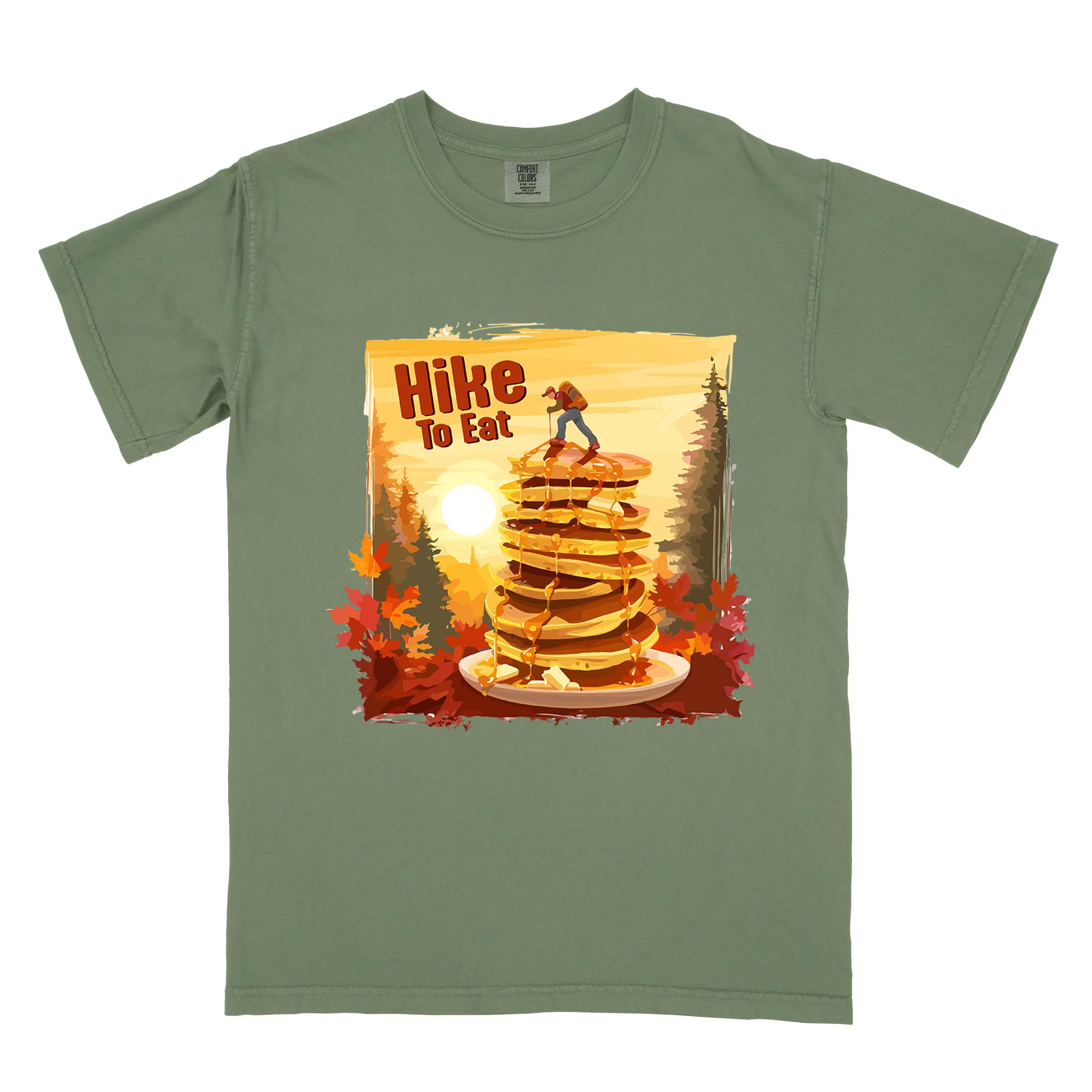 Moss "Hike to Eat" colored vintage statement tee with text in bold lettering, mountains, birds, silhouette, illustrated stack of pancake, and perfect for breakfast lovers.
