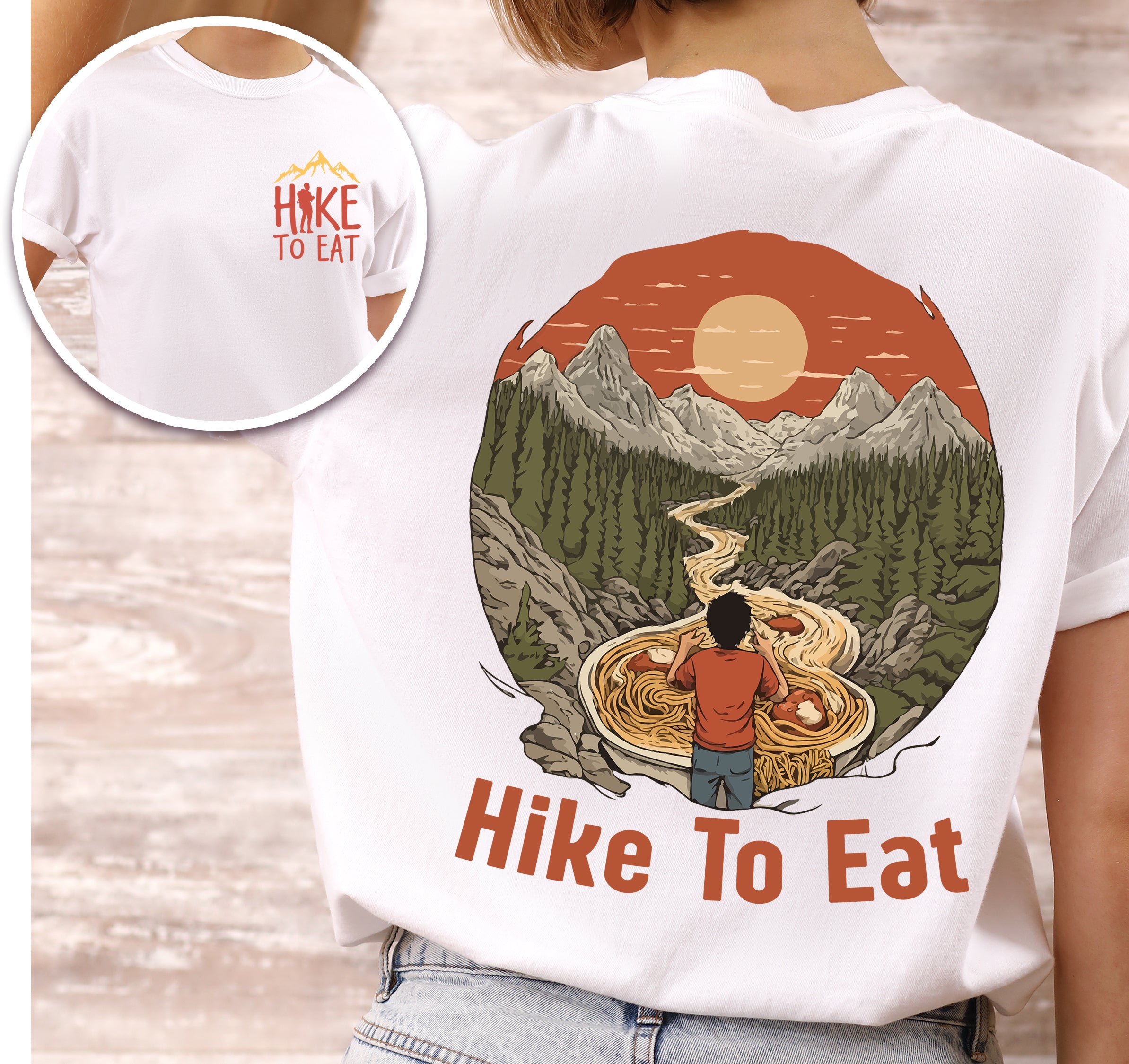 White Hike to Eat t-shirt front and back view showing small colorful chest detail and large back design featuring hiker standing by steaming bowl of noodles in circular mountain landscape with orange sunset and winding trail.