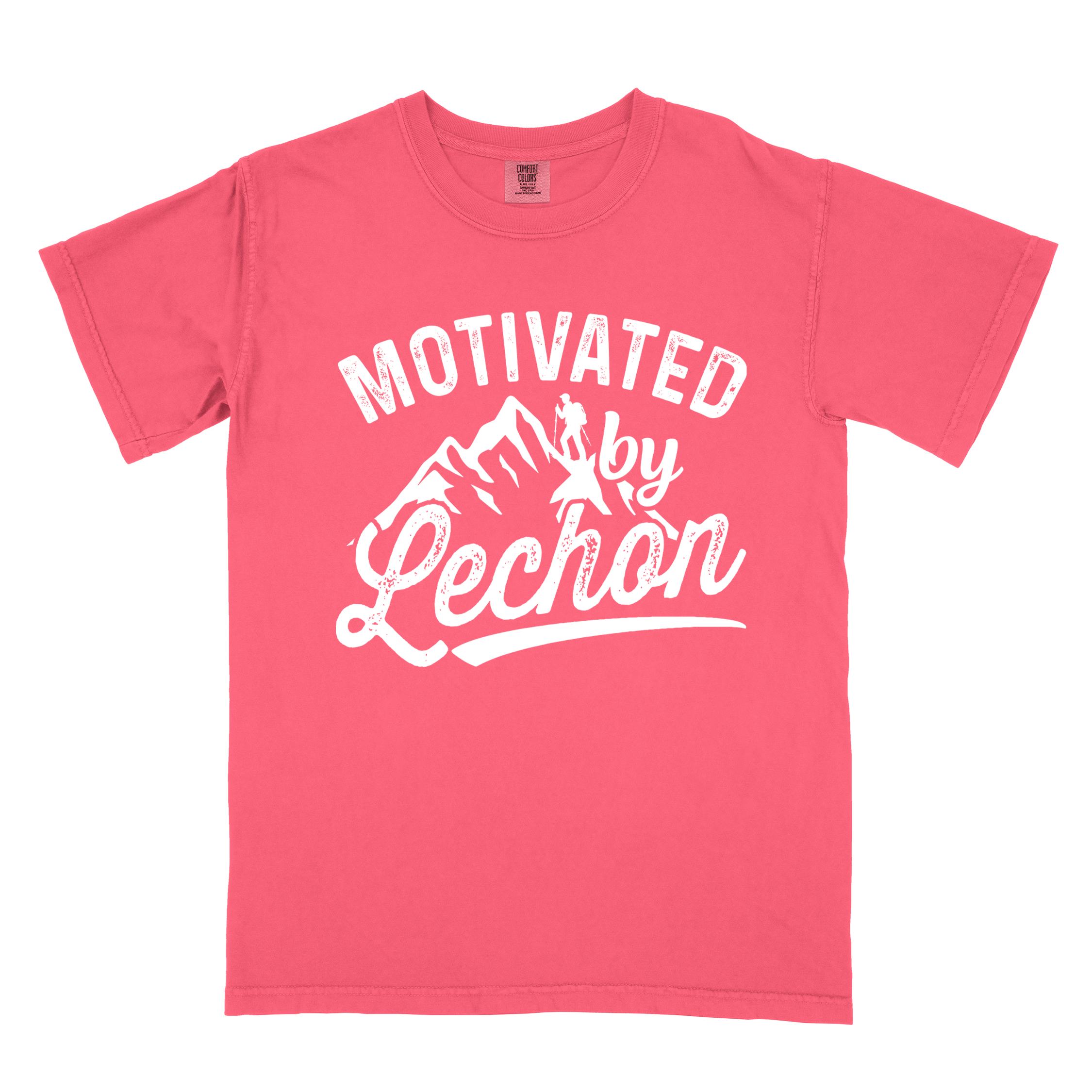 Watermelon colored graphic t-shirt with 'Motivated by Lechon' text in white lettering featuring mountain silhouettes and hiker illustration