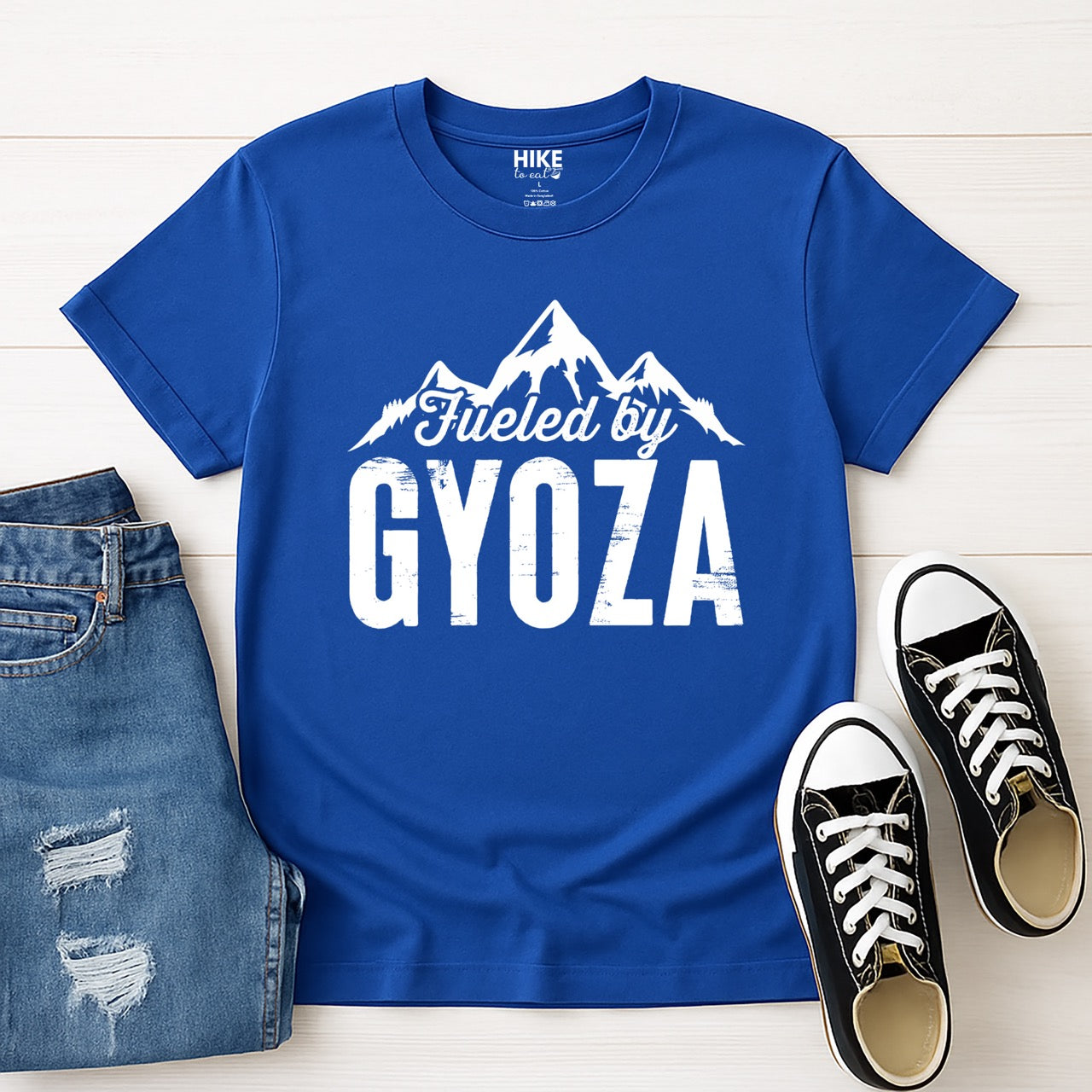 royal (blue) Fueled by Gyoza statement tee with distressed bold typography and mountain peaks for dumpling enthusiasts and hikers