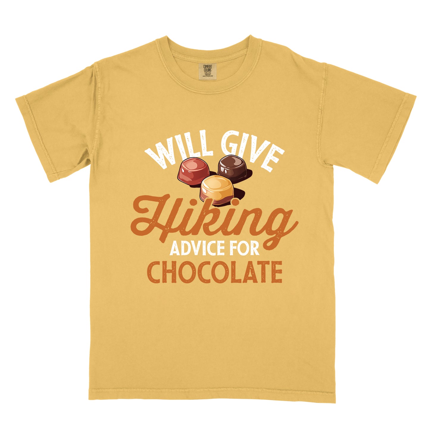 Mustard (Yellow) t-shirt with text reading "WILL GIVE Hiking ADVICE FOR CHOCOLATE". The words "WILL GIVE" appear in white distressed text at the top, "Hiking" in orange script in the middle, "ADVICE FOR" in white, and "CHOCOLATE" in orange at the bottom. Above the word "Hiking" is an illustration of three chocolate bonbons in different colors (dark, milk, and caramel).