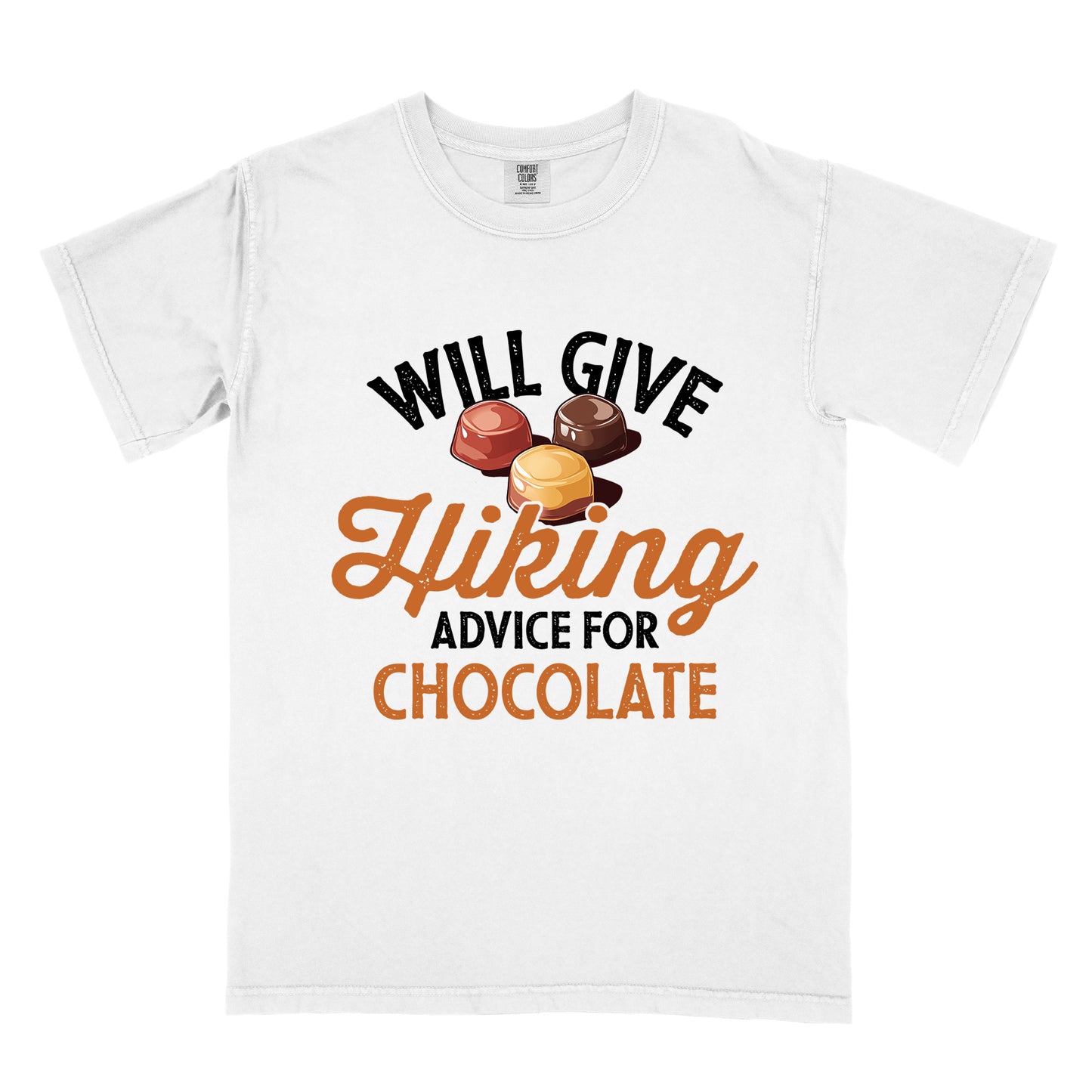 White t-shirt with text reading "WILL GIVE Hiking ADVICE FOR CHOCOLATE". The words "WILL GIVE" appear in black distressed text at the top, "Hiking" in orange script in the middle, "ADVICE FOR" in black, and "CHOCOLATE" in orange at the bottom. Above the word "Hiking" is an illustration of three chocolate bonbons in different colors (dark, milk, and caramel).