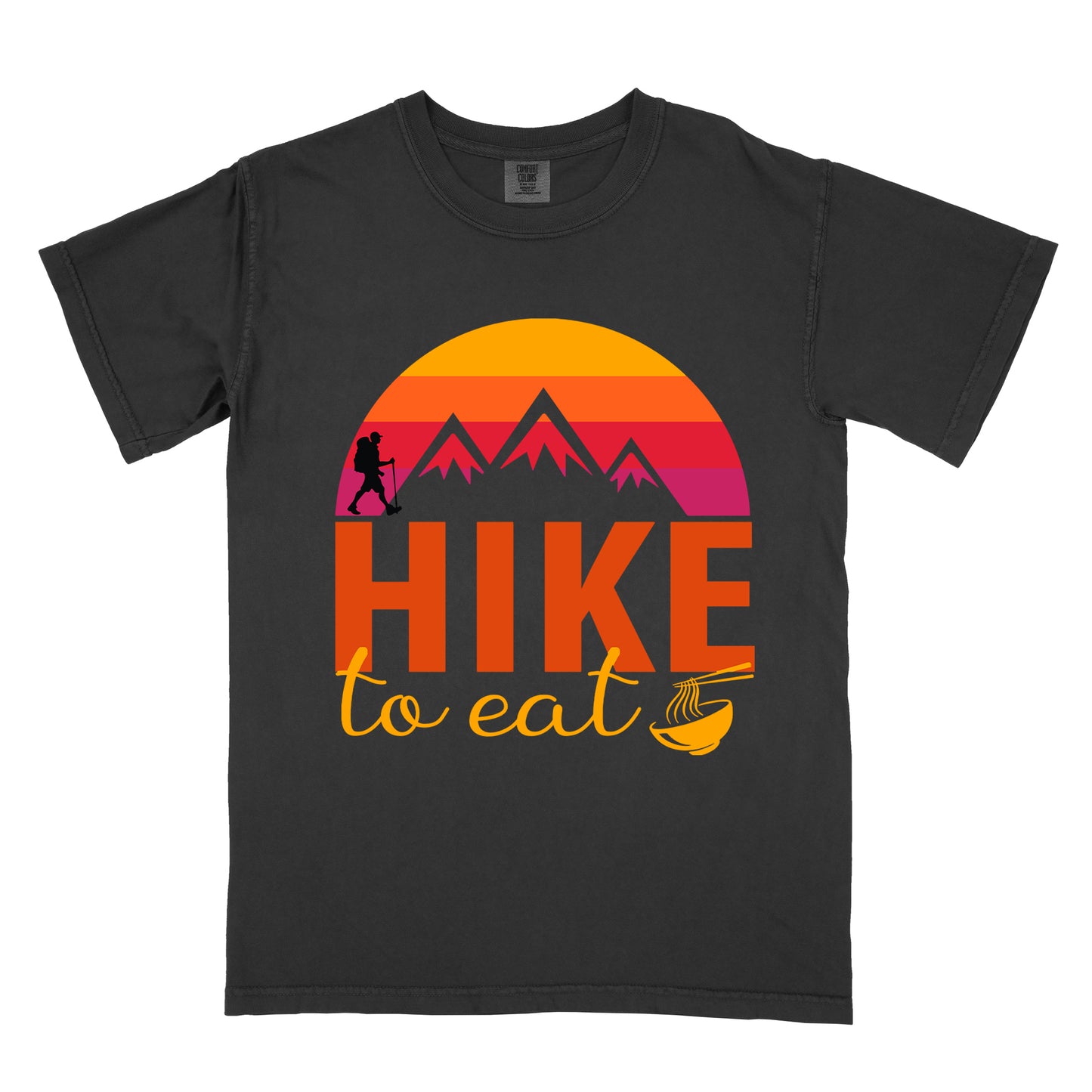 Black t-shirt featuring a retro sunset design with gradient colors from yellow to orange to red to purple. Mountain silhouettes and a small hiker figure appear against the sunset. Below this is "HIKE" in large orange letters and "to eat" in yellow script, followed by a small illustration of a noodle bowl with chopsticks. The design has a vintage outdoor aesthetic.