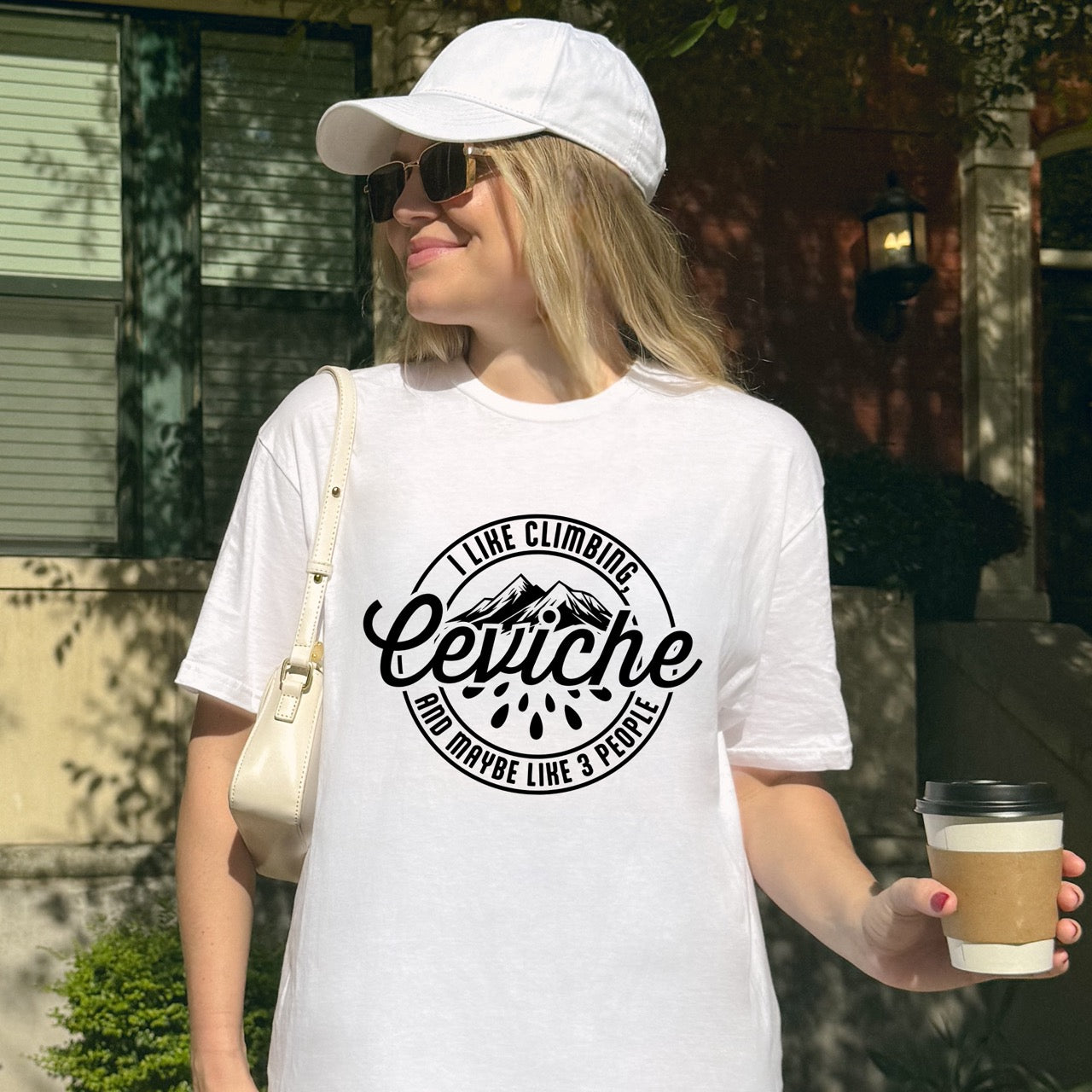 Woman wearing WhiteI like Climbing, Ceviche and maybe 3 People funny introvert statement tee with circular badge design, mountain peaks, and citrus drops for seafood-loving climbers, hikers and foodies