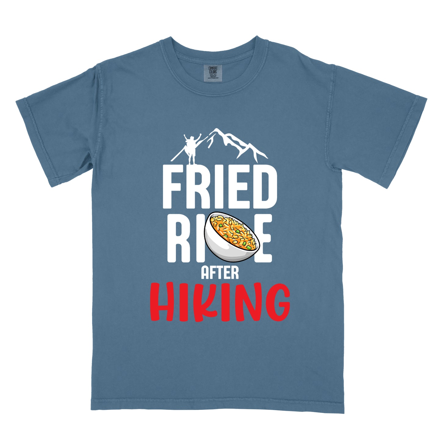 Blue Jean (Denim Blue) t-shirt with text "FRIED RICE AFTER HIKING". The top features white mountain silhouettes with a small hiker figure. "FRIED RICE" appears in large white letters with an illustration of a bowl of fried rice replacing the letter "C" in "RICE", tilted slightly to the right. The word "AFTER" is in small white text, and "HIKING" appears at the bottom in bold red letters.