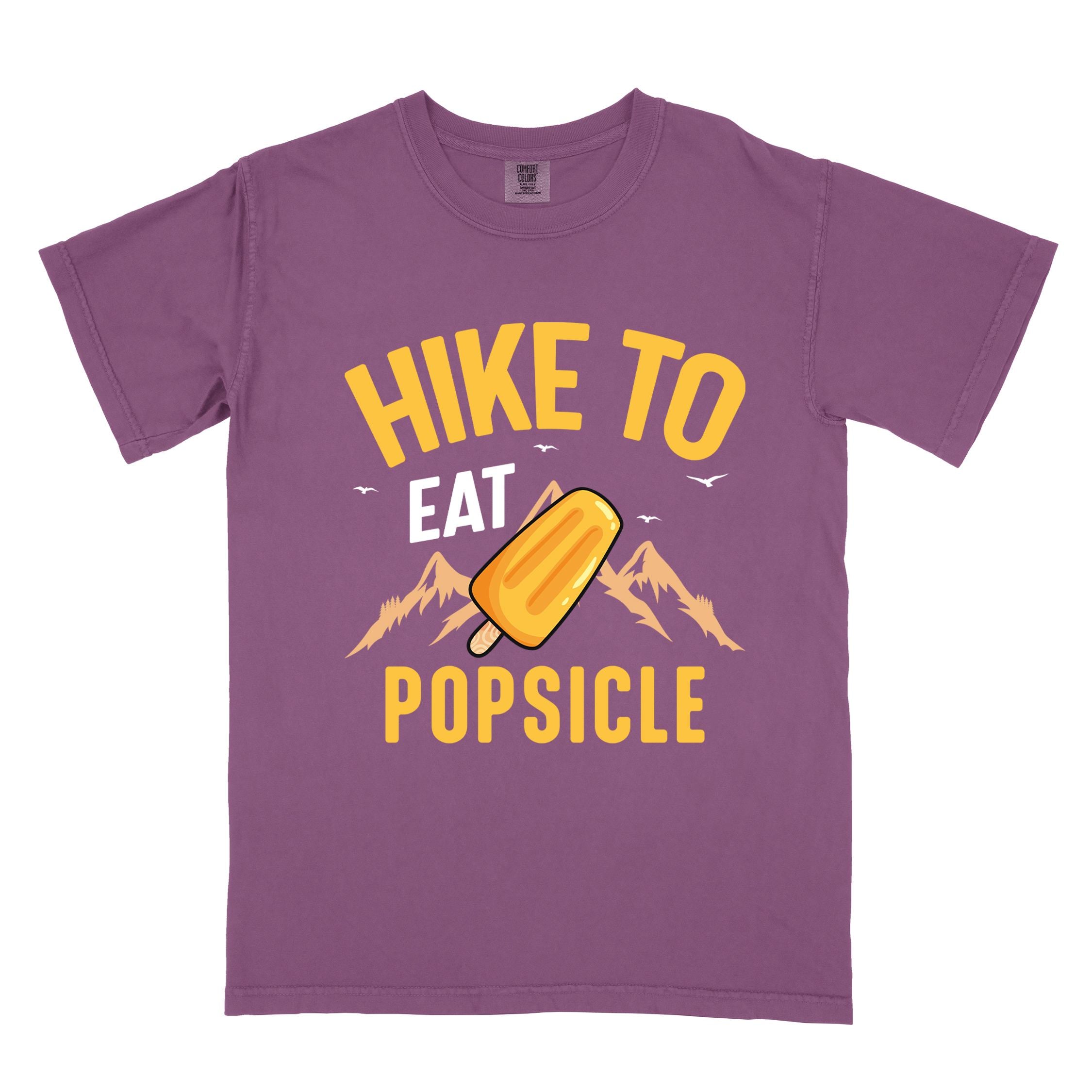 Berry "Hike to Eat Popsicle" colored vintage tee with bold typography, mountains, illustrated flavored popsicle, and backpackers with a sweet tooth.