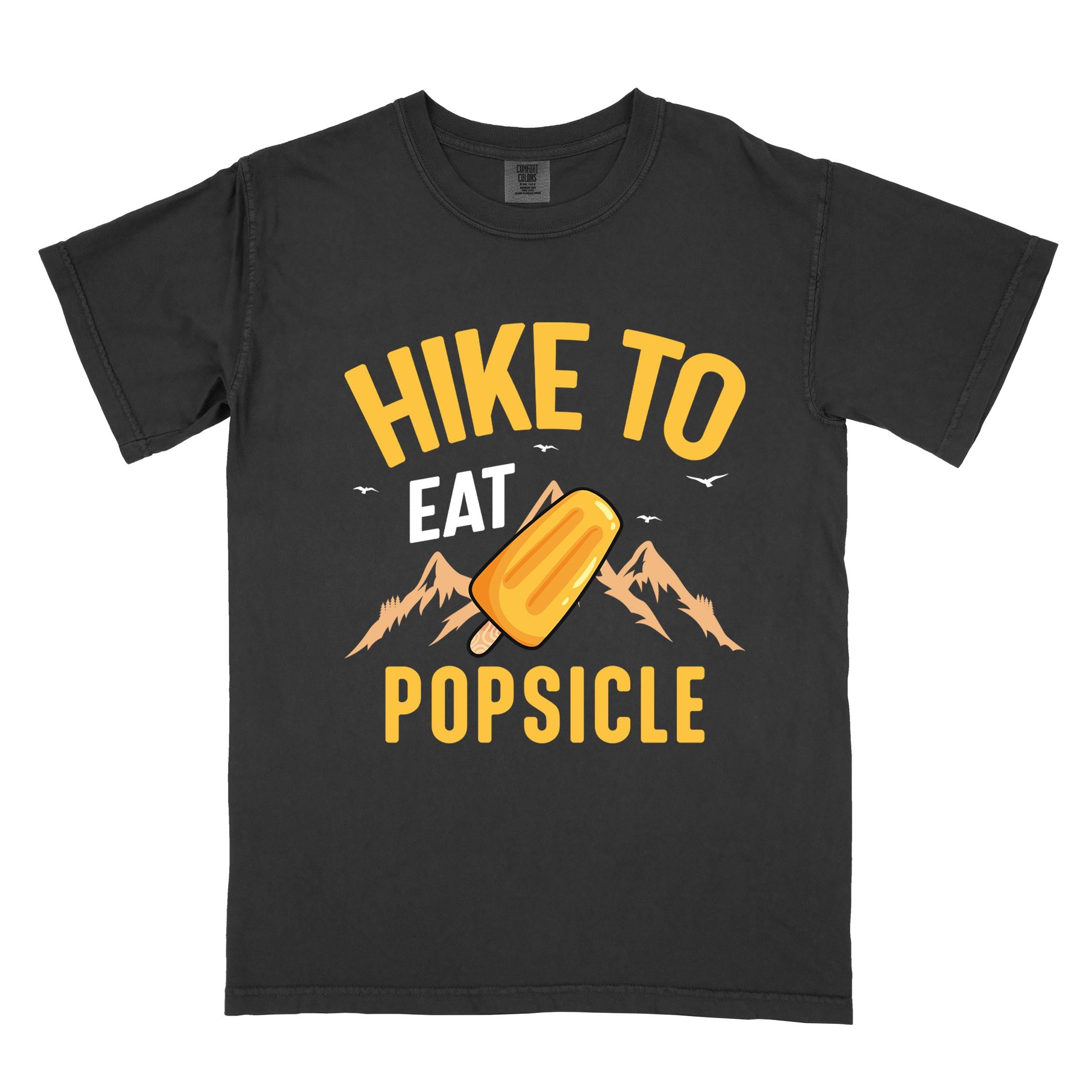 Black "Hike to Eat Popsicle" colored vintage tee with bold typography, mountains, illustrated flavored popsicle, and backpackers with a sweet tooth.