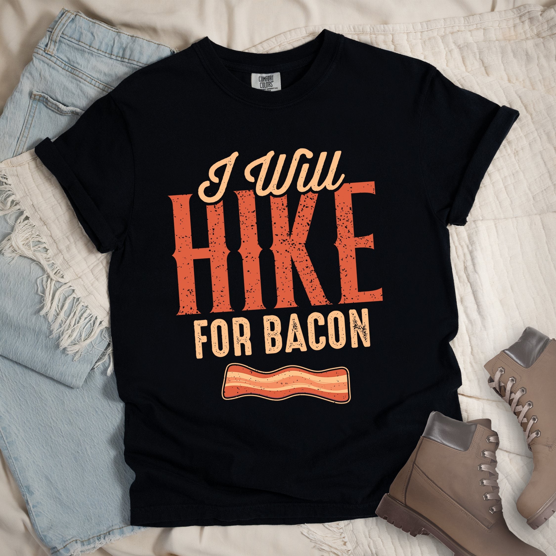 Black shirt with the text “I Will Hike for Bacon” and an illustration of a bacon strip.