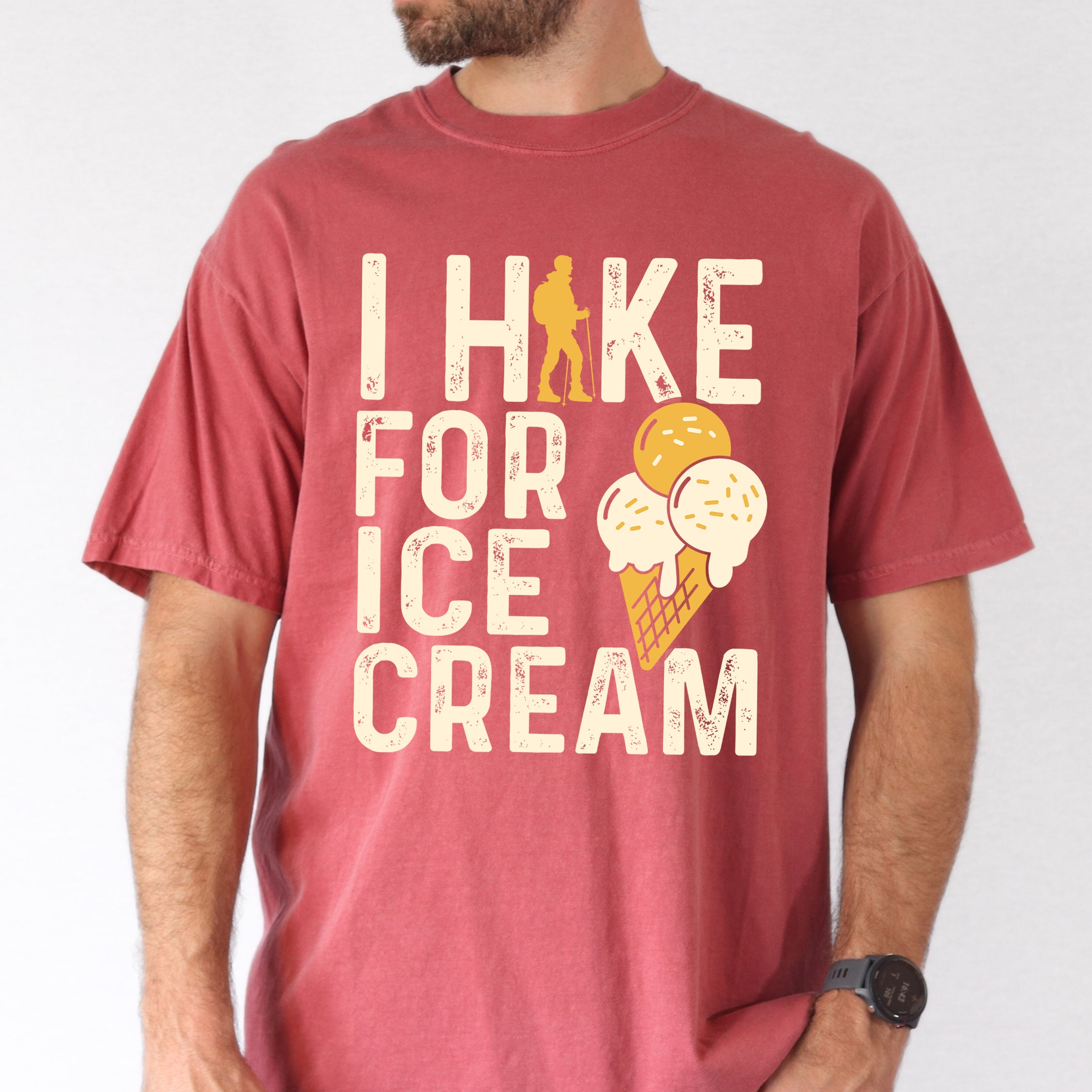 crimson (red) I Hike for Ice Cream statement tee with vintage distressed typography, hiker silhouette, and double-scoop ice cream cone illustration on Comfort Colors shirt for dessert-loving outdoor enthusiasts