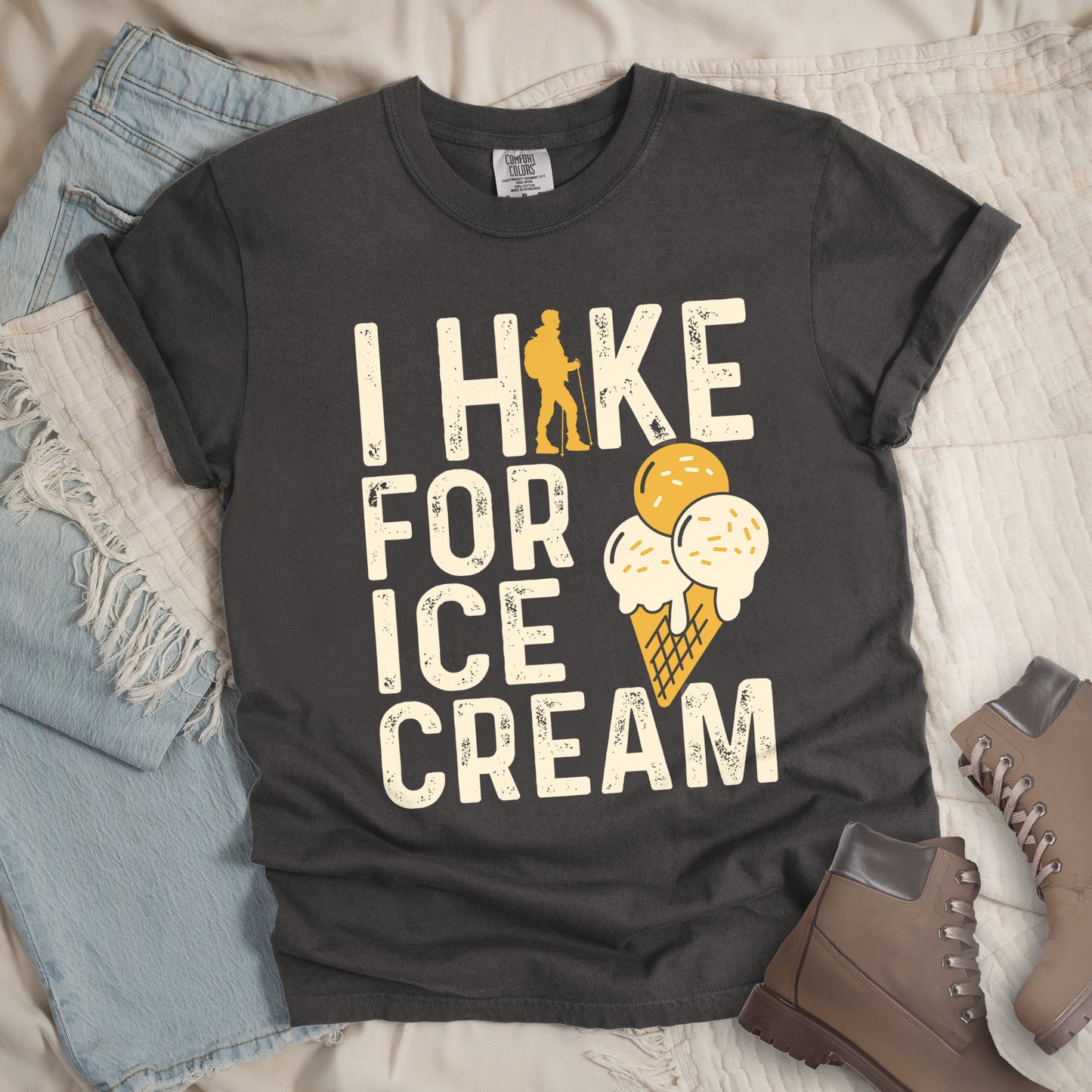 Pepper (Dark Gray) graphic t-shirt with 'I Hike for Ice Cream' text in cream lettering featuring orange hiker silhouette and vanilla and mango ice cream cone illustration with waffle cone.