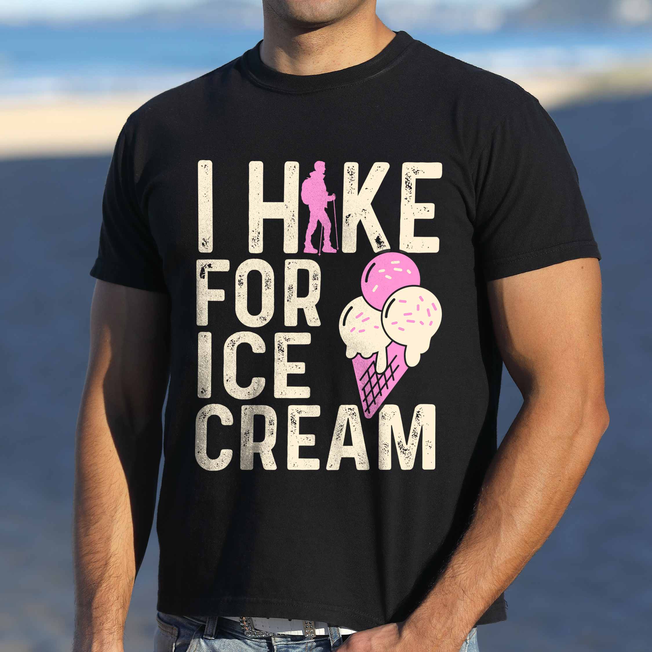 Man wearing black I Hike for Ice Cream statement tee with vintage distressed typography, hiker silhouette, and double-scoop ice cream cone illustration on Comfort Colors shirt for dessert-loving outdoor enthusiasts and hikers