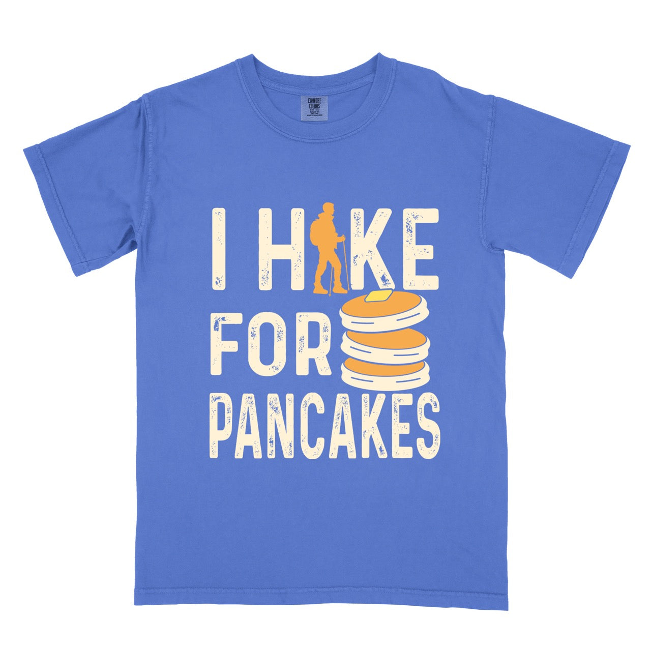 Flo Blue colored Pancake breakfast lover vintage tee I Hike for Pancakes with distressed cream typography character silhouette with trekking pole and illustrated stacked pancakes with butter on Comfort Colors shirt for brunch and food enthusiasts, hikers and foodies.