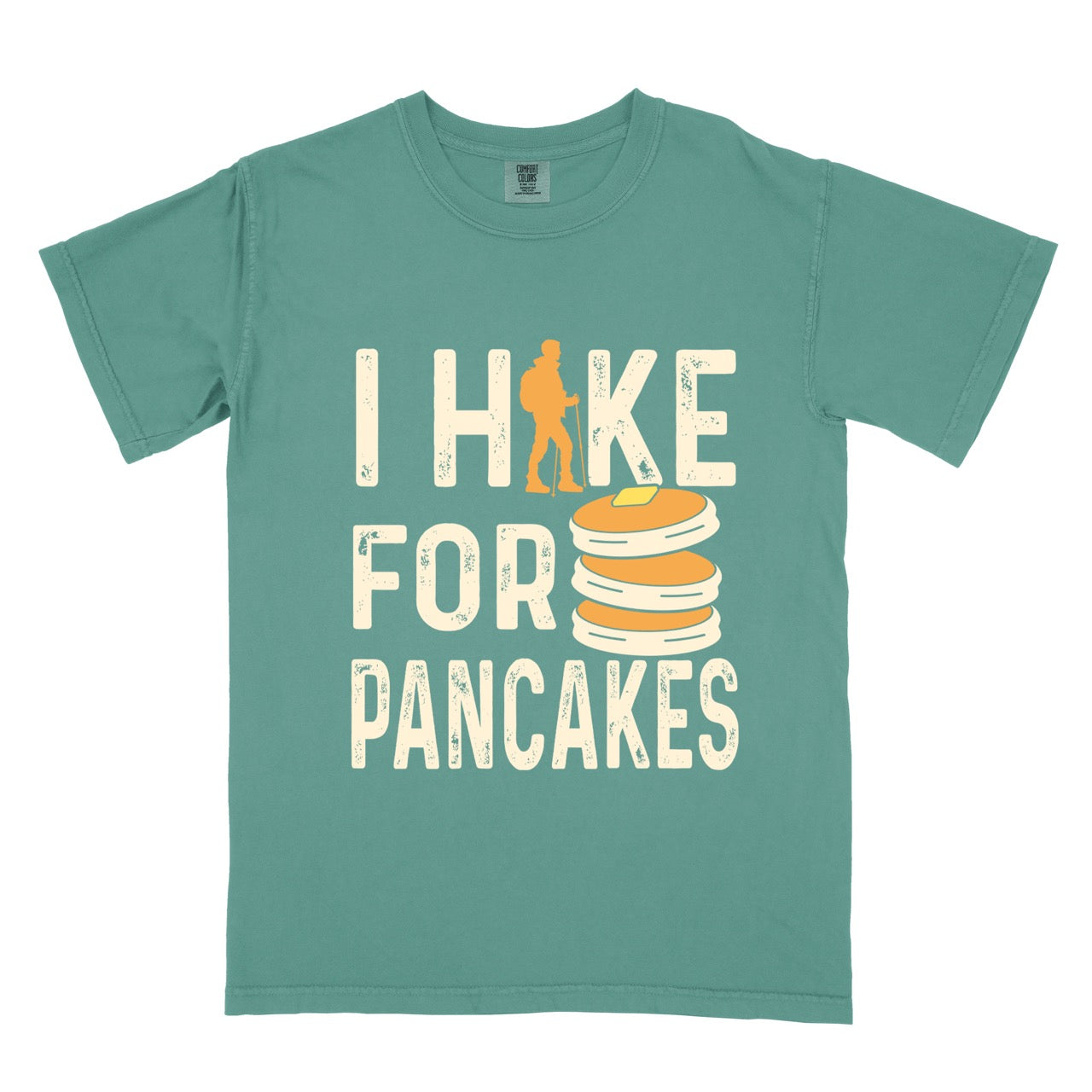 Light green Pancake breakfast lover vintage tee I Hike for Pancakes with distressed cream typography character silhouette with trekking pole and illustrated stacked pancakes with butter on Comfort Colors shirt for brunch and food enthusiasts, hikers and foodies.
