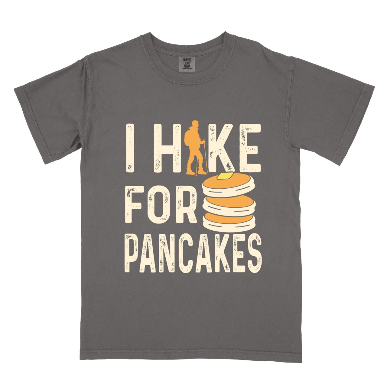 Pepper Pancake breakfast lover vintage tee I Hike for Pancakes with distressed cream typography character silhouette with trekking pole and illustrated stacked pancakes with butter on Comfort Colors shirt for brunch and food enthusiasts, hikers and foodies.