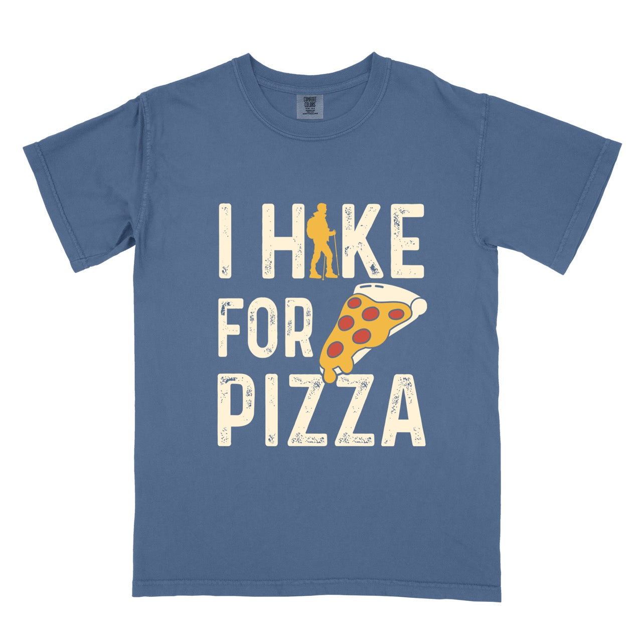 blue jean I Hike for Pizza graphic tee with distressed cream typography, pepperoni pizza slice illustration, and gold hiker silhouette on Comfort Colors shirt for Italian food enthusiasts and mountain trail lovers