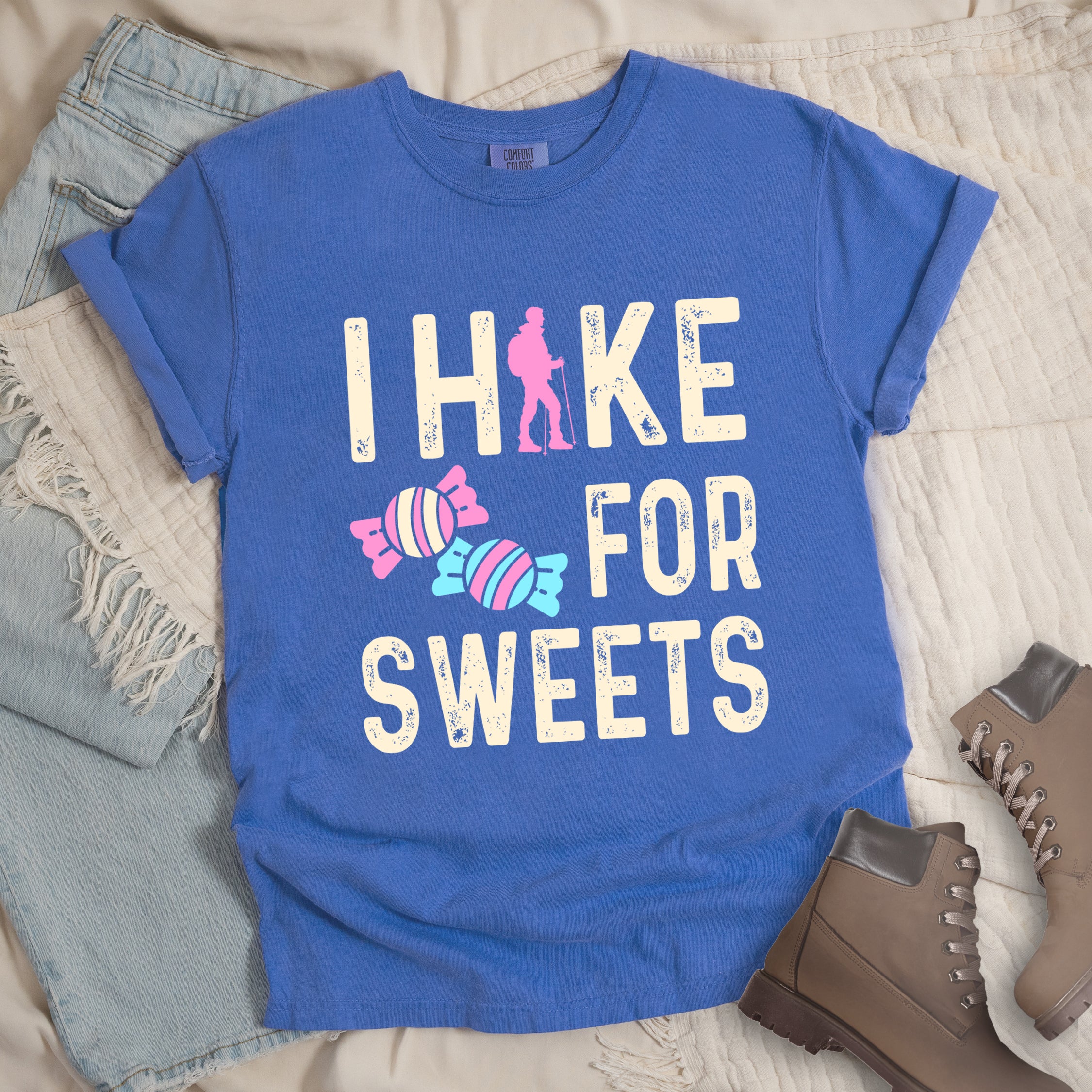 Flo Blue (Bright Blue) graphic t-shirt with 'I Hike for Sweets' text in cream lettering featuring pink hiker silhouette and colorful striped candy illustrations in pink and blue