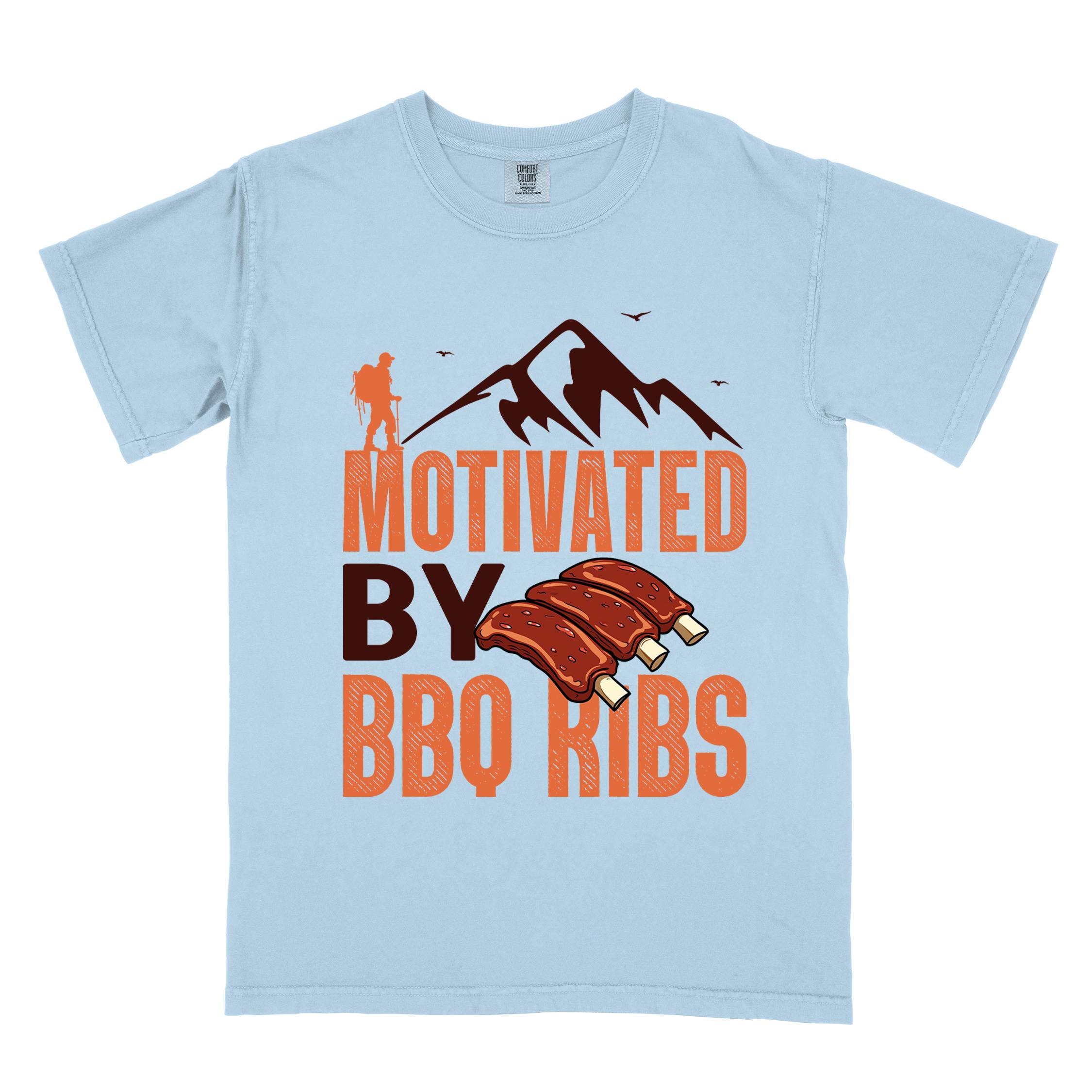 Chambray "Motivated by BBQ ribs" colored vintage tee with bold typography, mountains, juicy grilled bbq ribs illustration, and backpacker for bbq enthusiasts