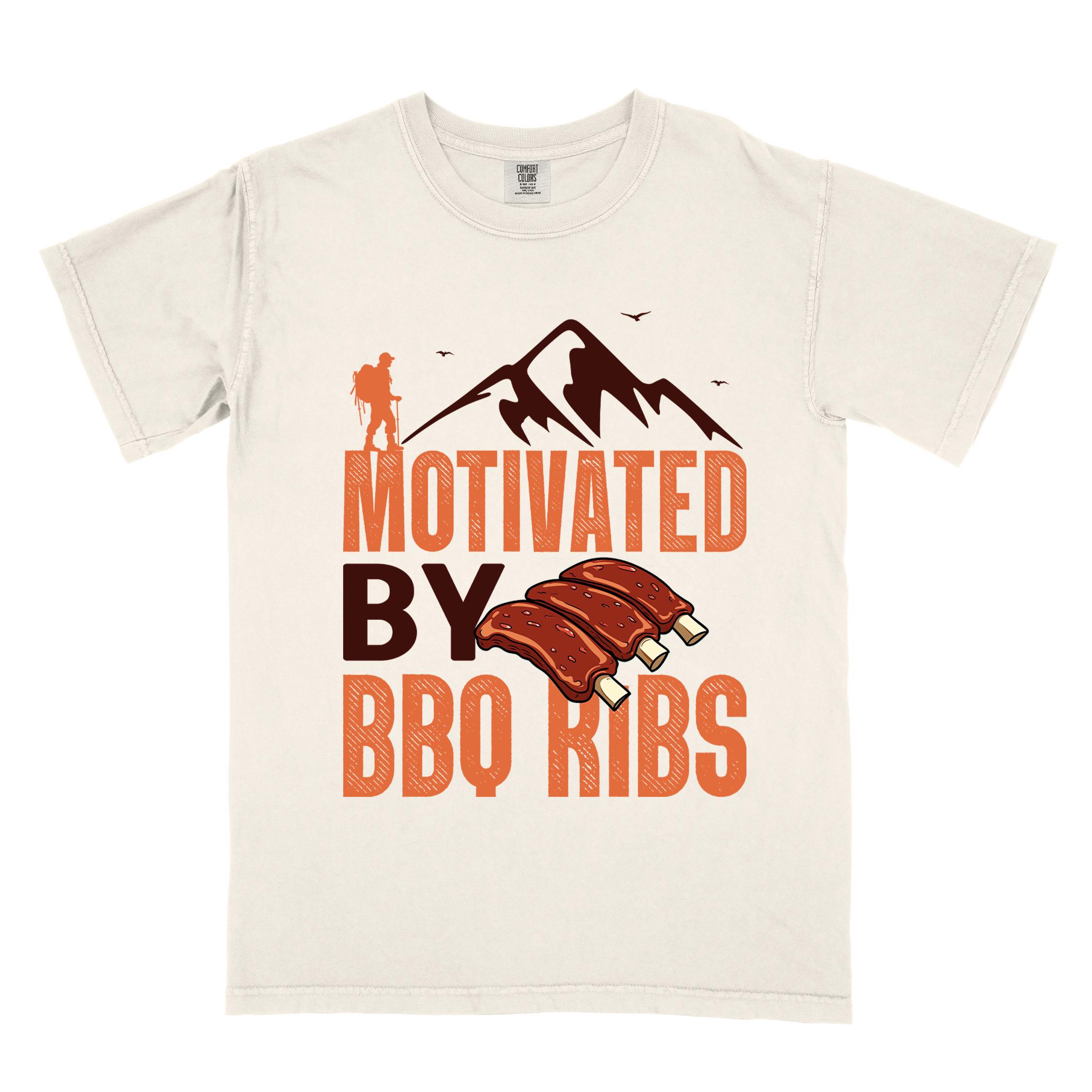 Ivory "Motivated by BBQ ribs" colored vintage tee with bold typography, mountains, juicy grilled bbq ribs illustration, and backpacker for bbq enthusiasts