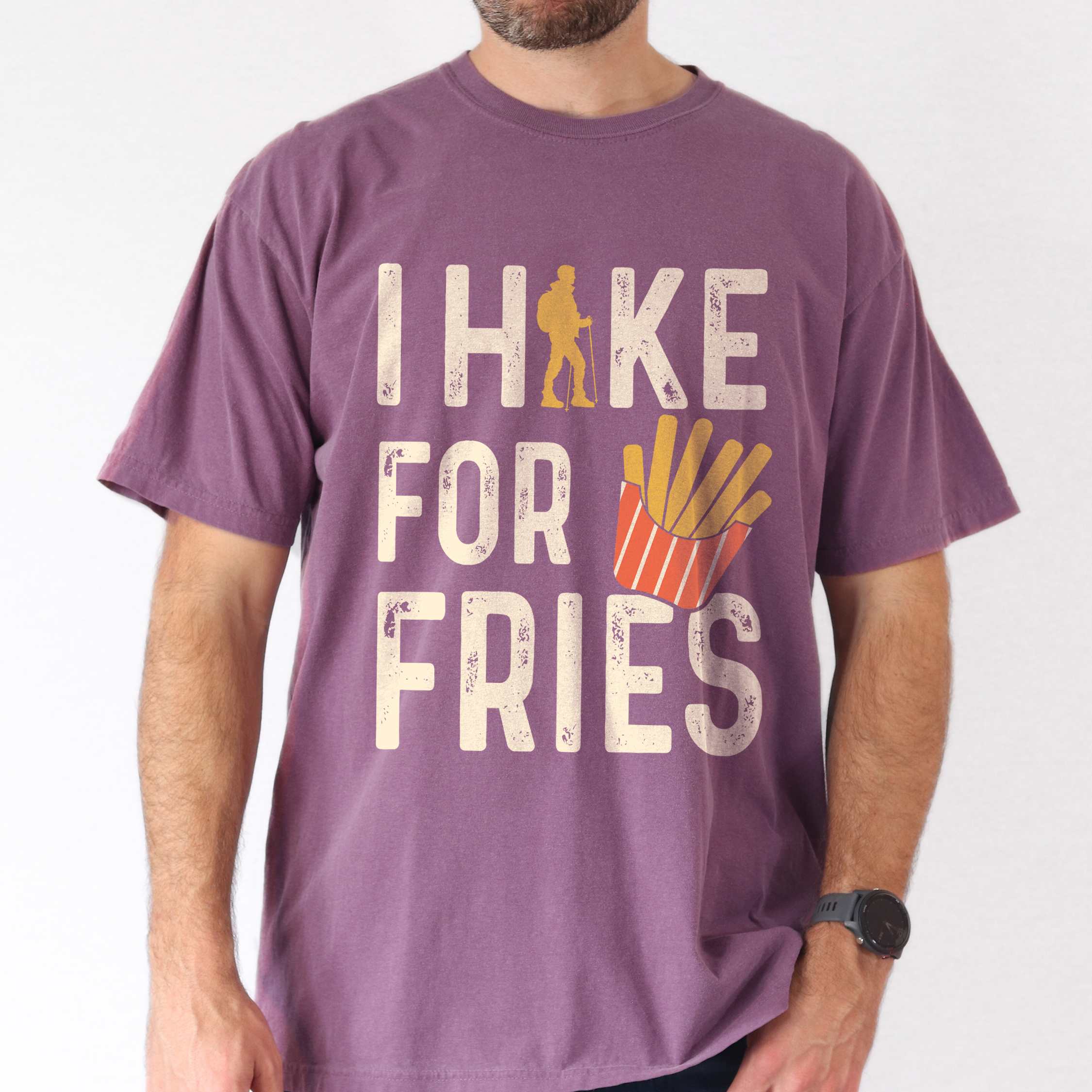 Man wearing berry 'I Hike for Tacos' text in cream lettering, illustrated french fries, and backpacker for french fries enthusiasts