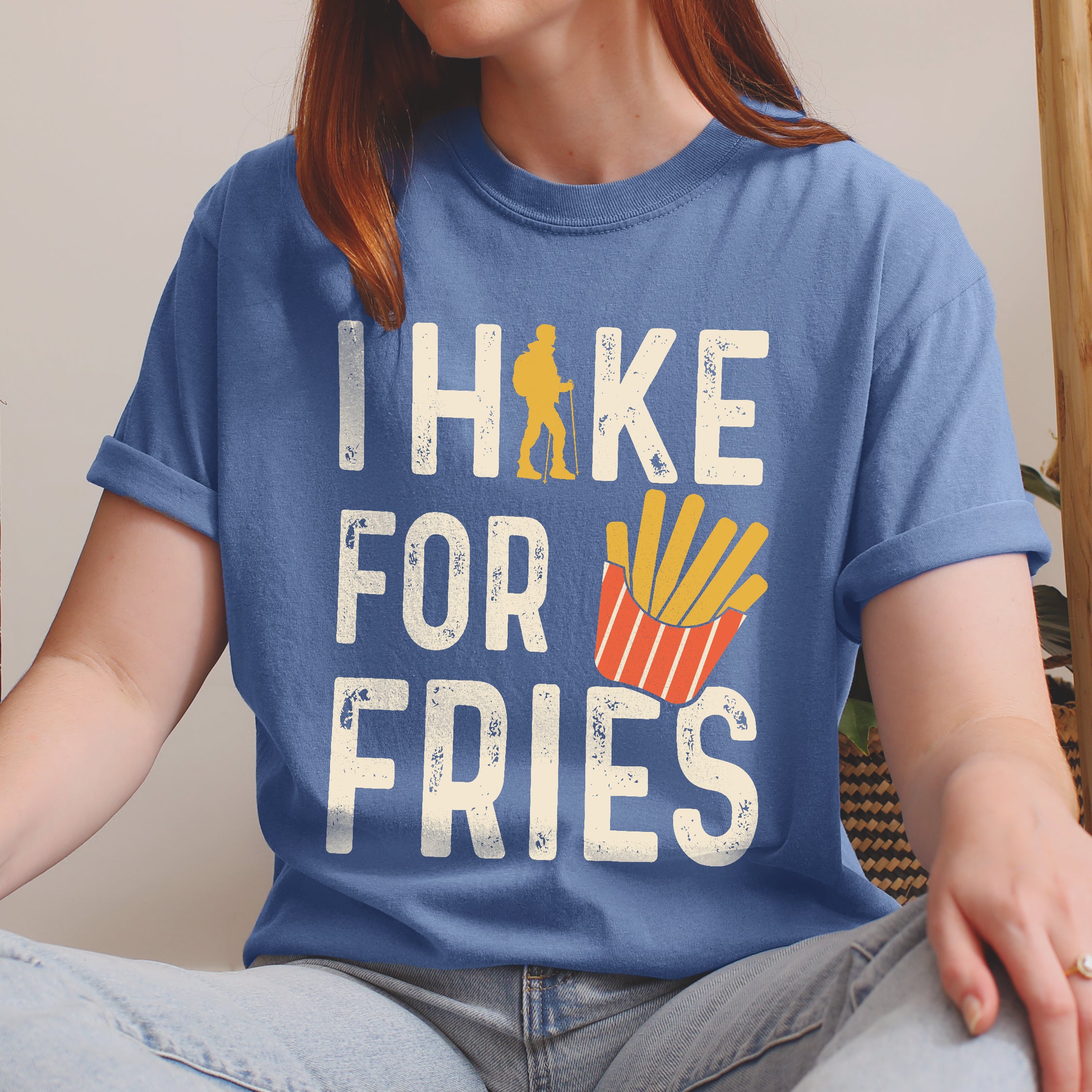 Blue Jean (Denim Blue) graphic t-shirt with 'I Hike for Fries' text in cream lettering featuring yellow hiker silhouette and french fries illustration in red container.