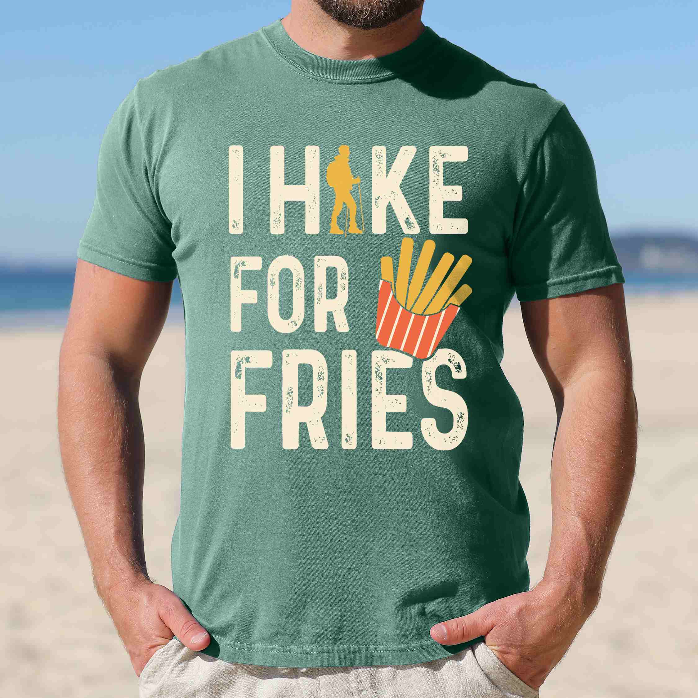 Man wearing light green 'I Hike for Tacos' text in cream lettering, illustrated french fries, and backpacker for french fries enthusiasts