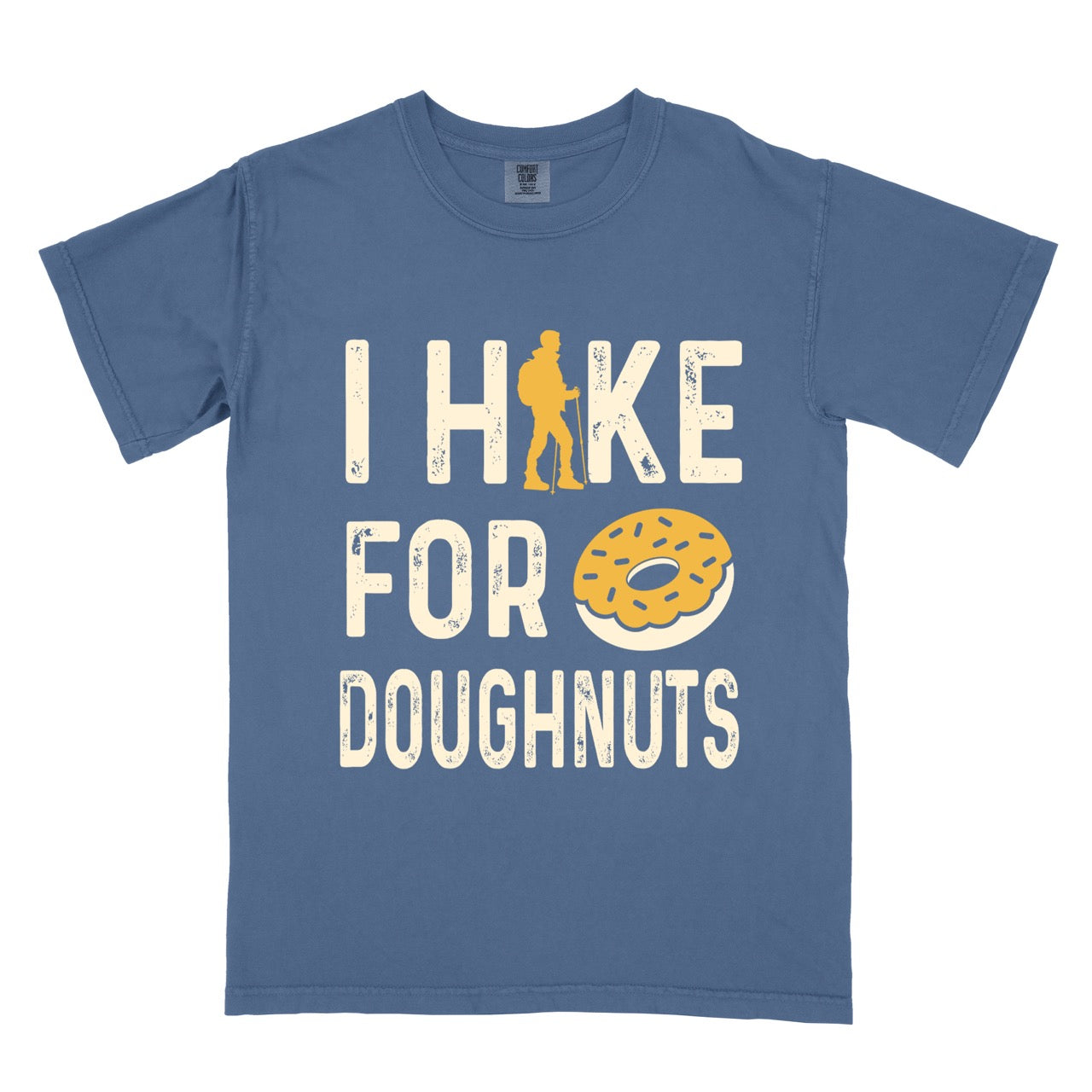 Blue Jean (blue) Doughnut donut lover statement tee I Hike for Doughnuts with vintage distressed cream typography character silhouette with trekking pole and illustrated glazed doughnut with sprinkles on Comfort Colors shirt for sweet treat enthusiasts, hikers and foodies.
