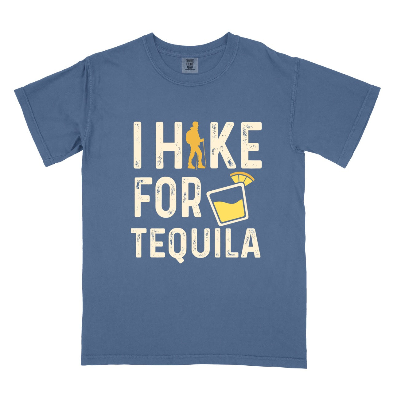 Blue Jean (blue) Tequila margarita lover statement tee I Hike for Tequila with vintage distressed cream typography character silhouette with trekking pole and illustrated tilted margarita glass with lime garnish on Comfort Colors shirt for drink enthusiasts for hikers and foodies.
