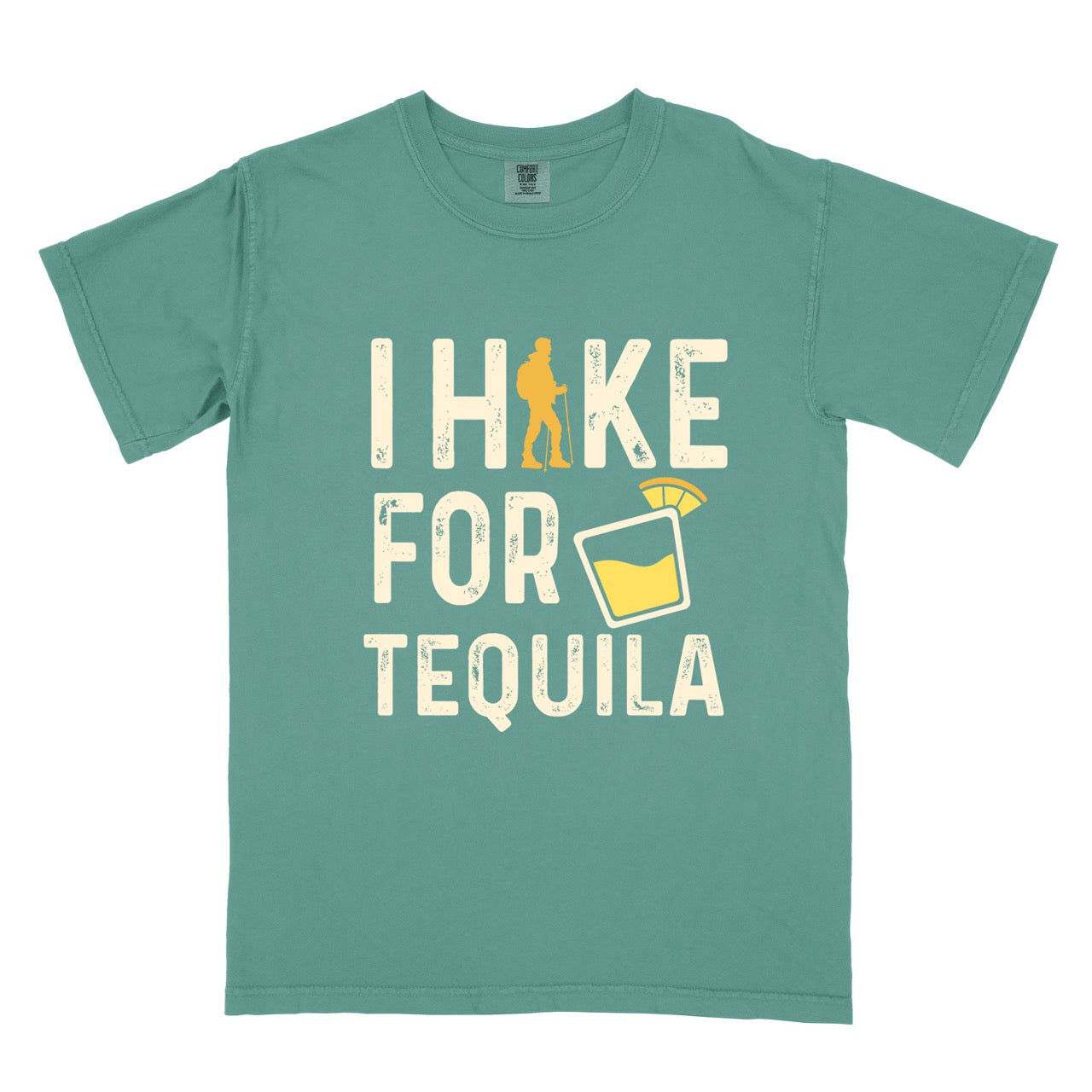 Light green Tequila margarita lover statement tee I Hike for Tequila with vintage distressed cream typography character silhouette with trekking pole and illustrated tilted margarita glass with lime garnish on Comfort Colors shirt for drink enthusiasts for hikers and foodies.