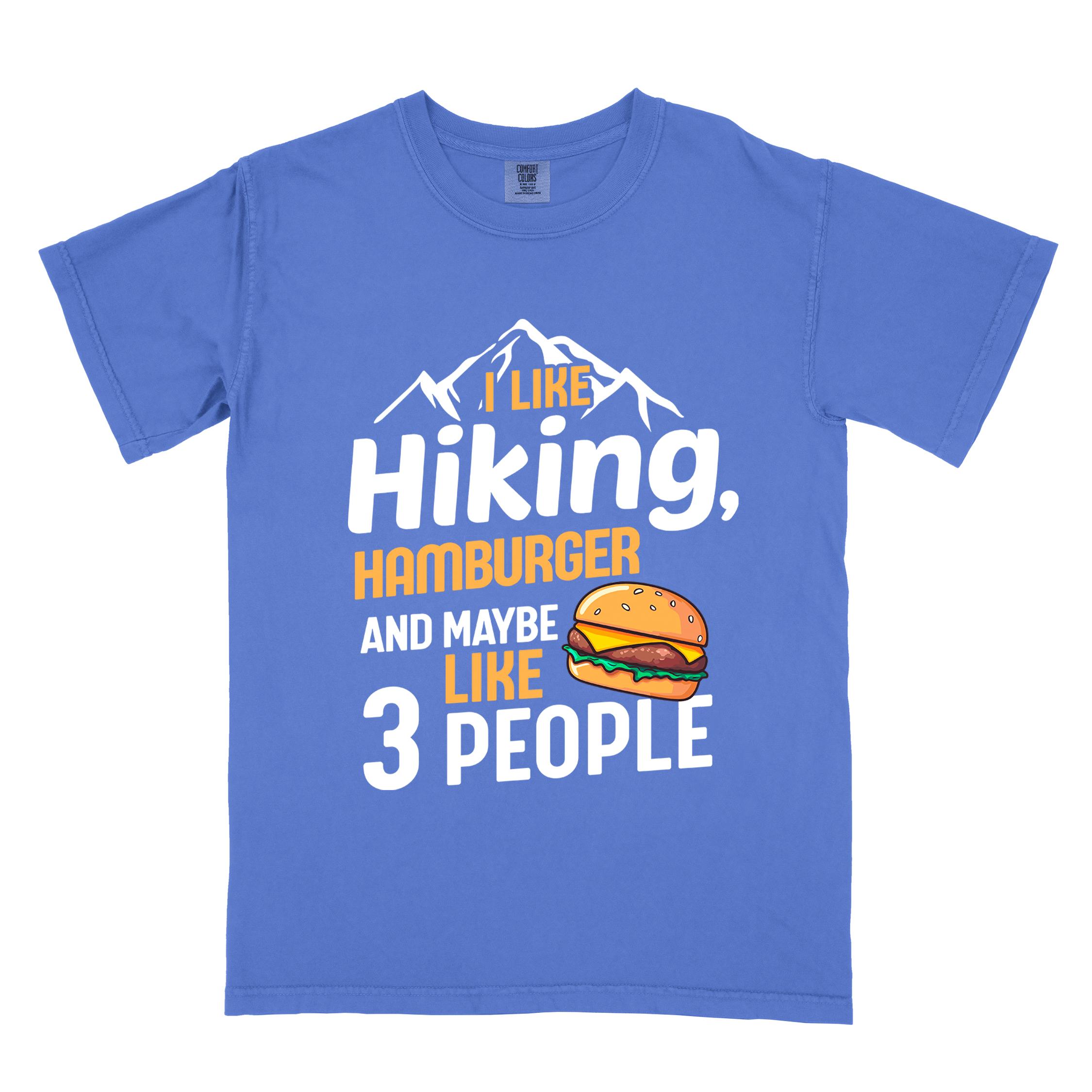 Flo blue "I like hiking, hamburger and maybe like three people" colored vintage tee with bold typography, birds, mountains, illustrated juicy hamburger, and backpacker for burger enthusiasts.
