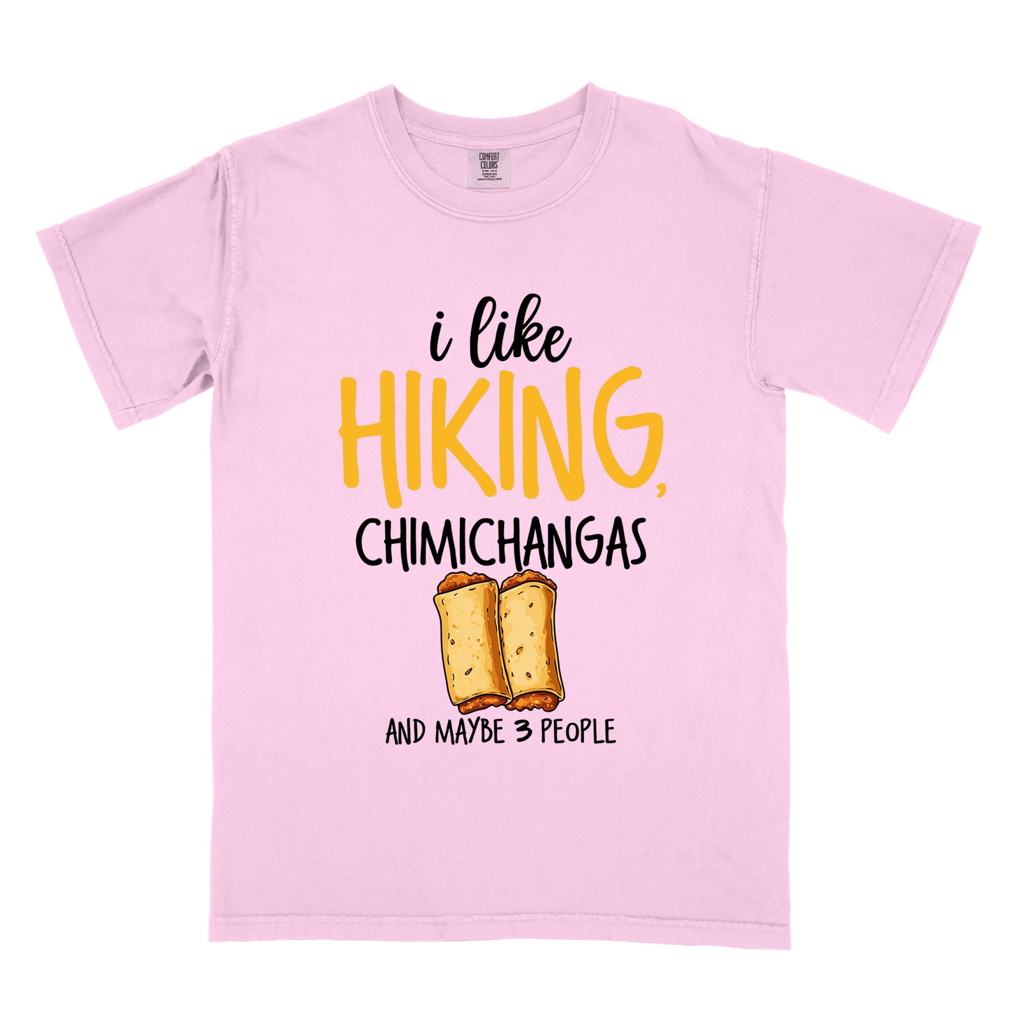 Blossom (Light Pink) t-shirt with text "i like HIKING, CHIMICHANGAS AND MAYBE 3 PEOPLE". The phrase "i like" appears in black script at the top, "HIKING," in yellow letters, "CHIMICHANGAS" in black, and "AND MAYBE 3 PEOPLE" in black at the bottom. Between "CHIMICHANGAS" and "AND MAYBE 3 PEOPLE" is an illustration of two chimichangas (fried burritos) with visible fillings. The design combines hiking, food, and introvert humor.