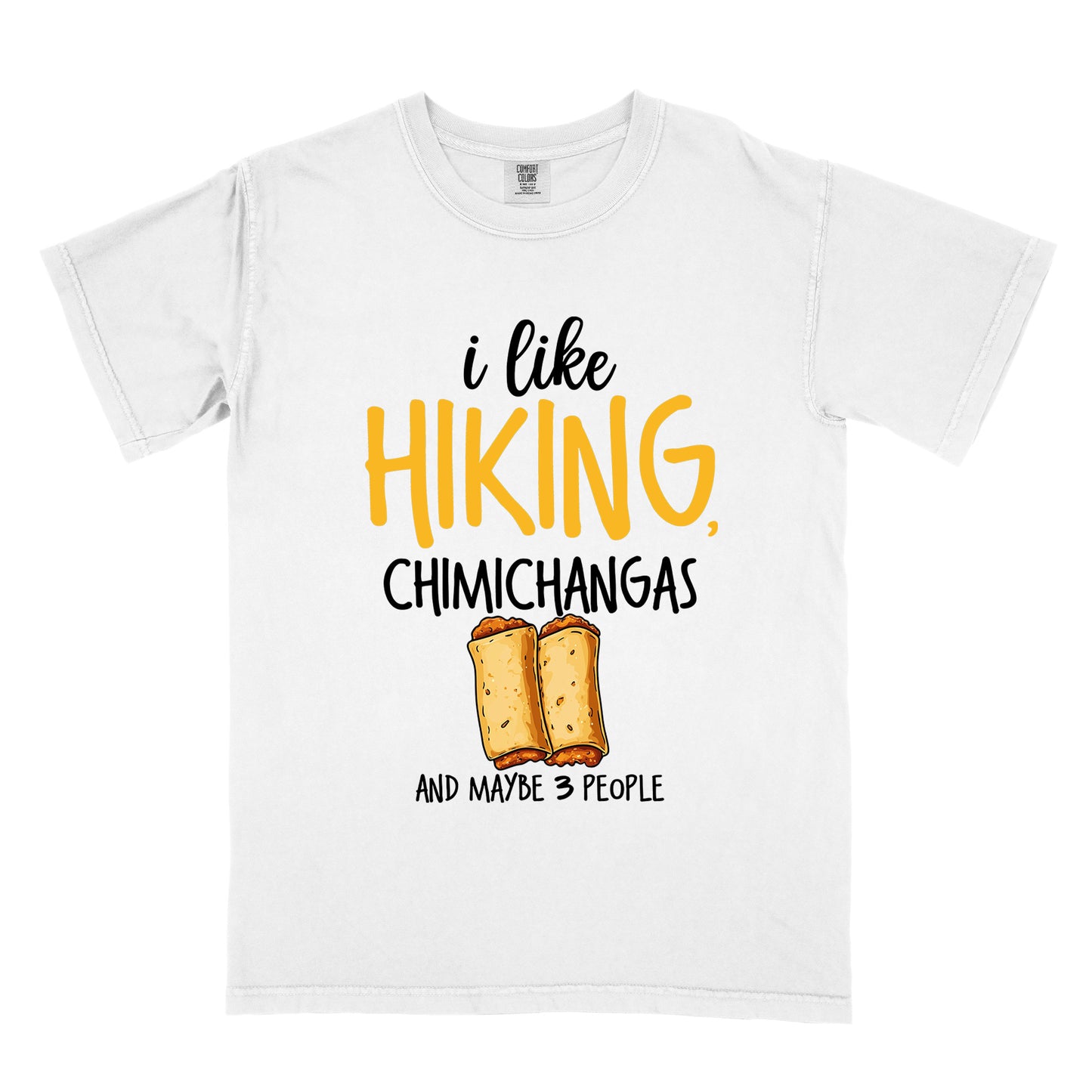 White t-shirt with text "i like HIKING, CHIMICHANGAS AND MAYBE 3 PEOPLE". The phrase "i like" appears in black script at the top, "HIKING," in yellow letters, "CHIMICHANGAS" in black, and "AND MAYBE 3 PEOPLE" in black at the bottom. Between "CHIMICHANGAS" and "AND MAYBE 3 PEOPLE" is an illustration of two chimichangas (fried burritos) with visible fillings. The design combines hiking, food, and introvert humor.