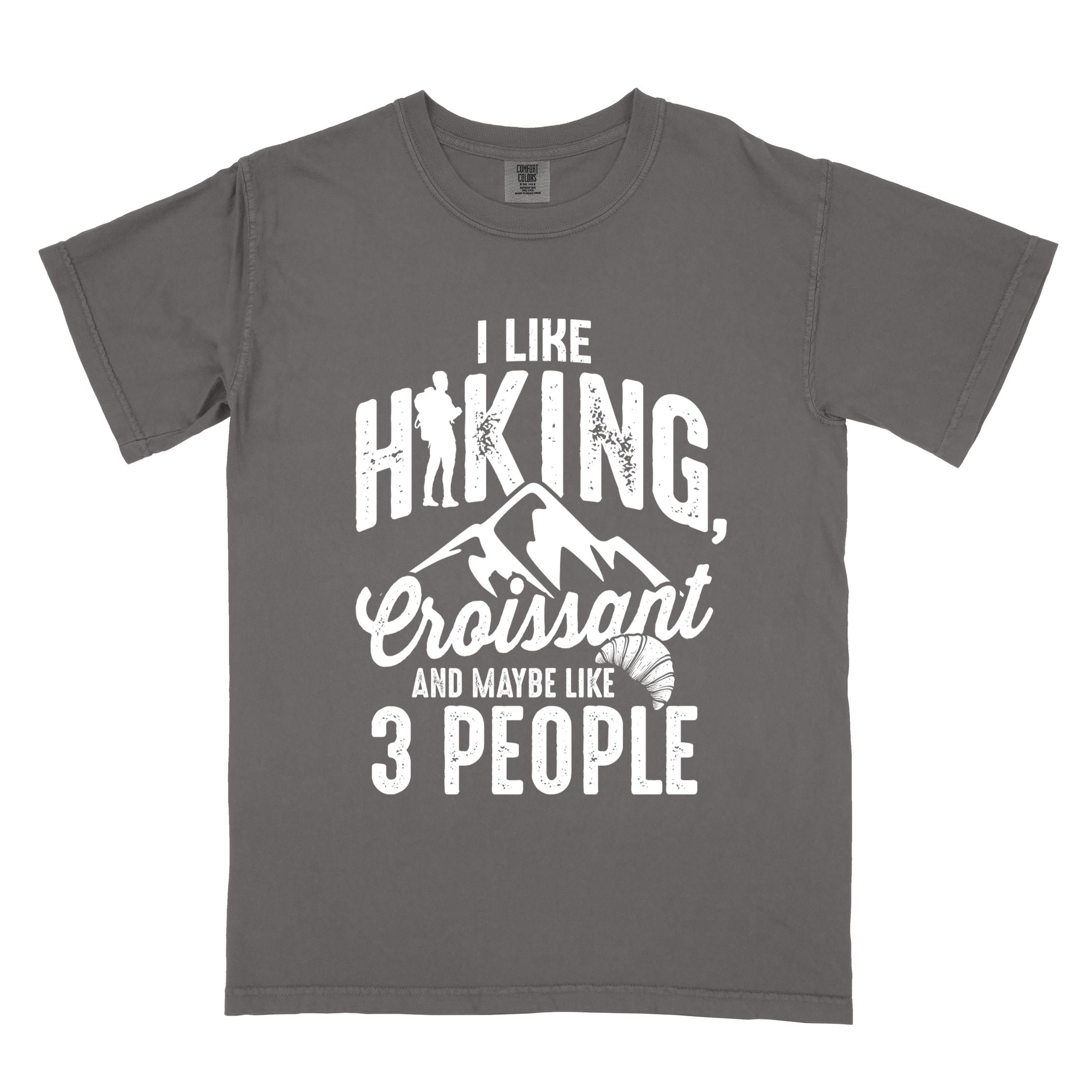 Pepper "I Like hiking, croissant and maybe like 3 people" colored vintage tee with bold typography, birds, mountains, illustrated croissant, and backpacker for pastry enthusiasts.