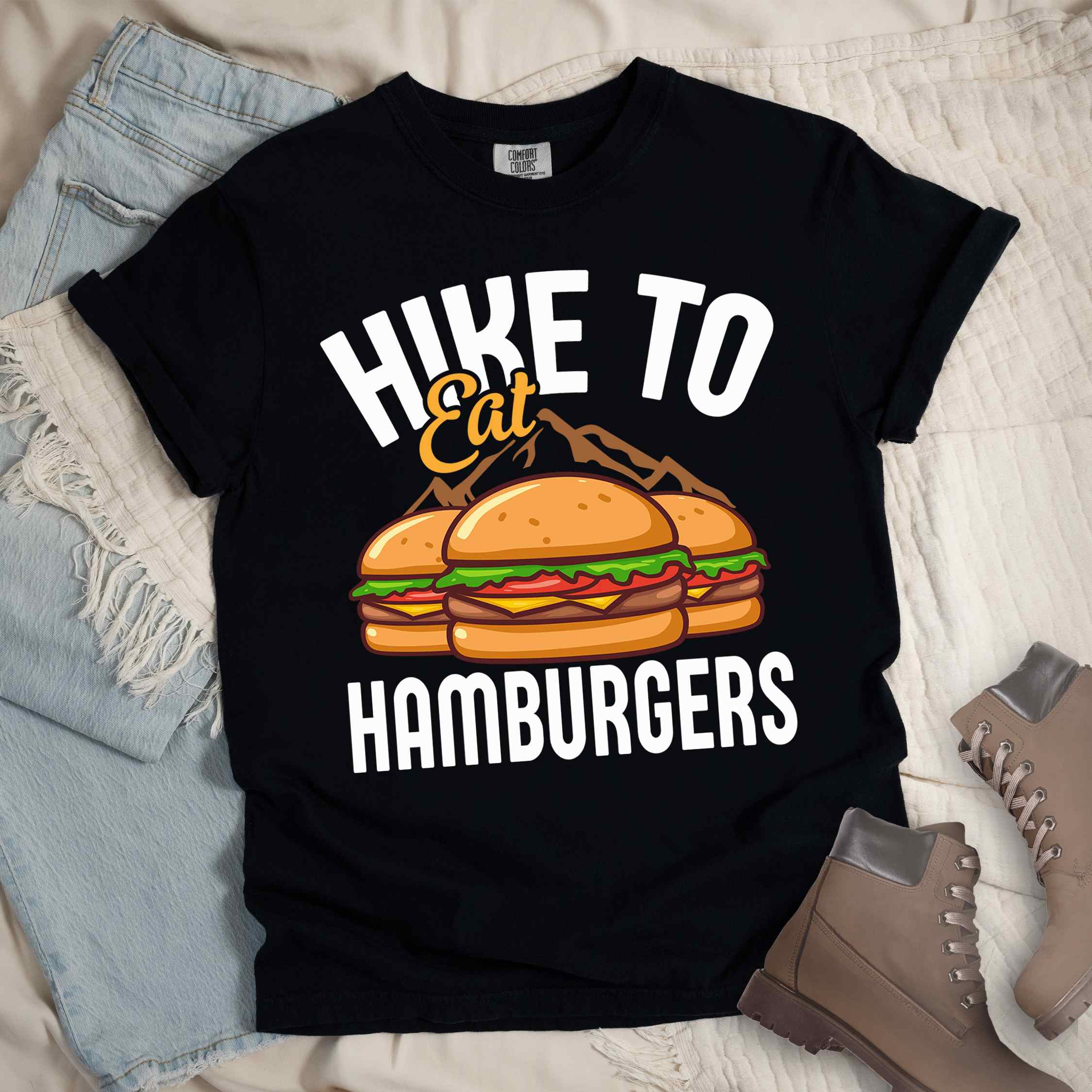 Black "Hike to Eat Hamburgers" colored vintage tee with bold typography, illustrated juicy hamburger, and backpacker for burger enthusiasts.