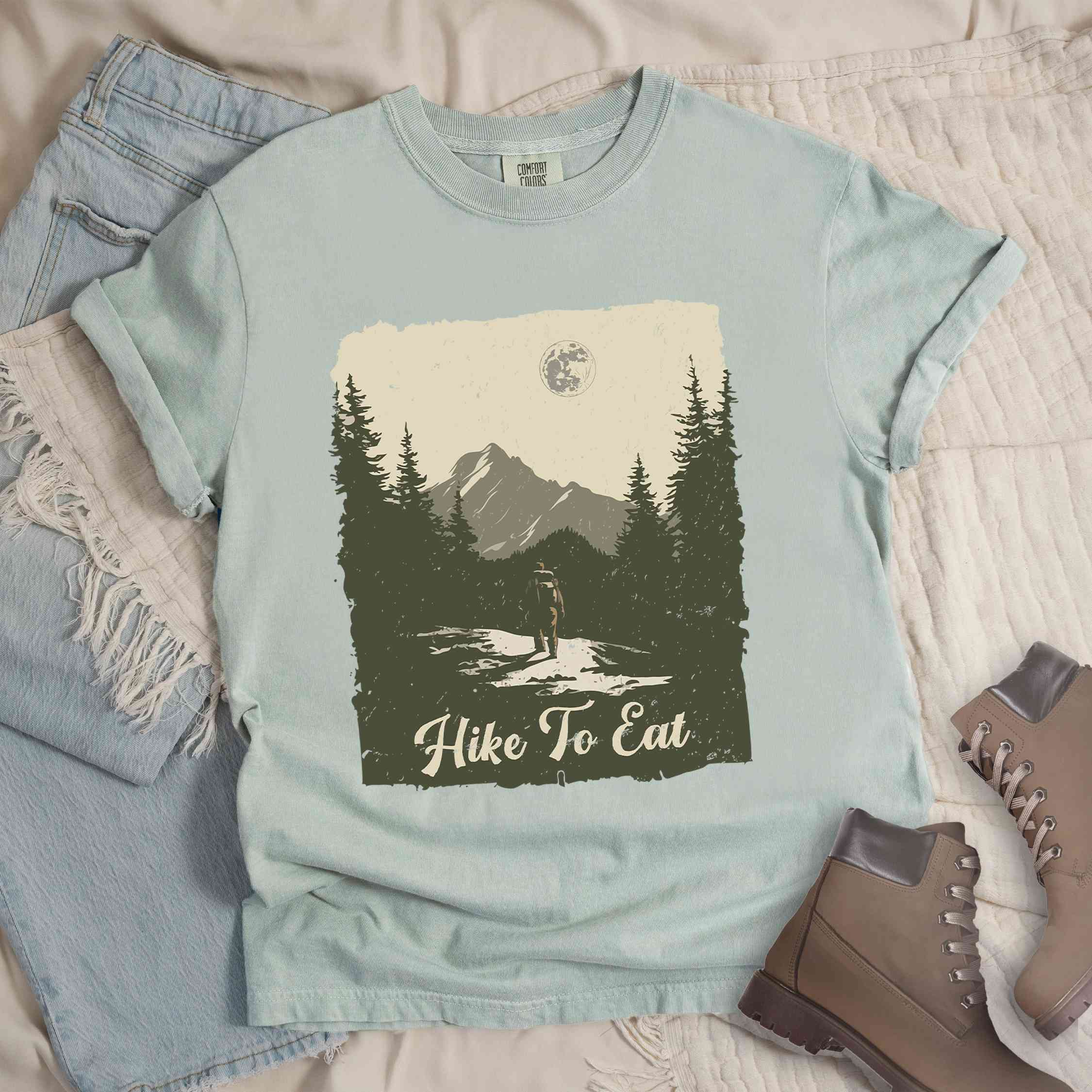 Bay "Hike to Eat" colored vintage tee with bold typography, illustrated landscape, and backpacker for burger enthusiasts.